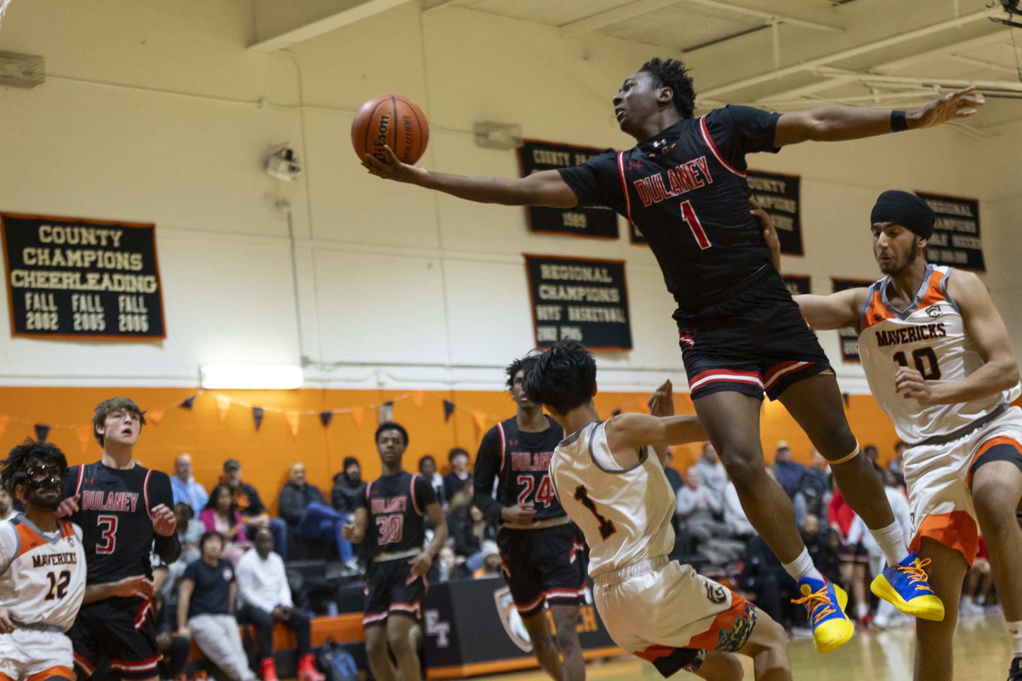 Dulaney’s Kelan Dennis maneuvers in the air to get off...
