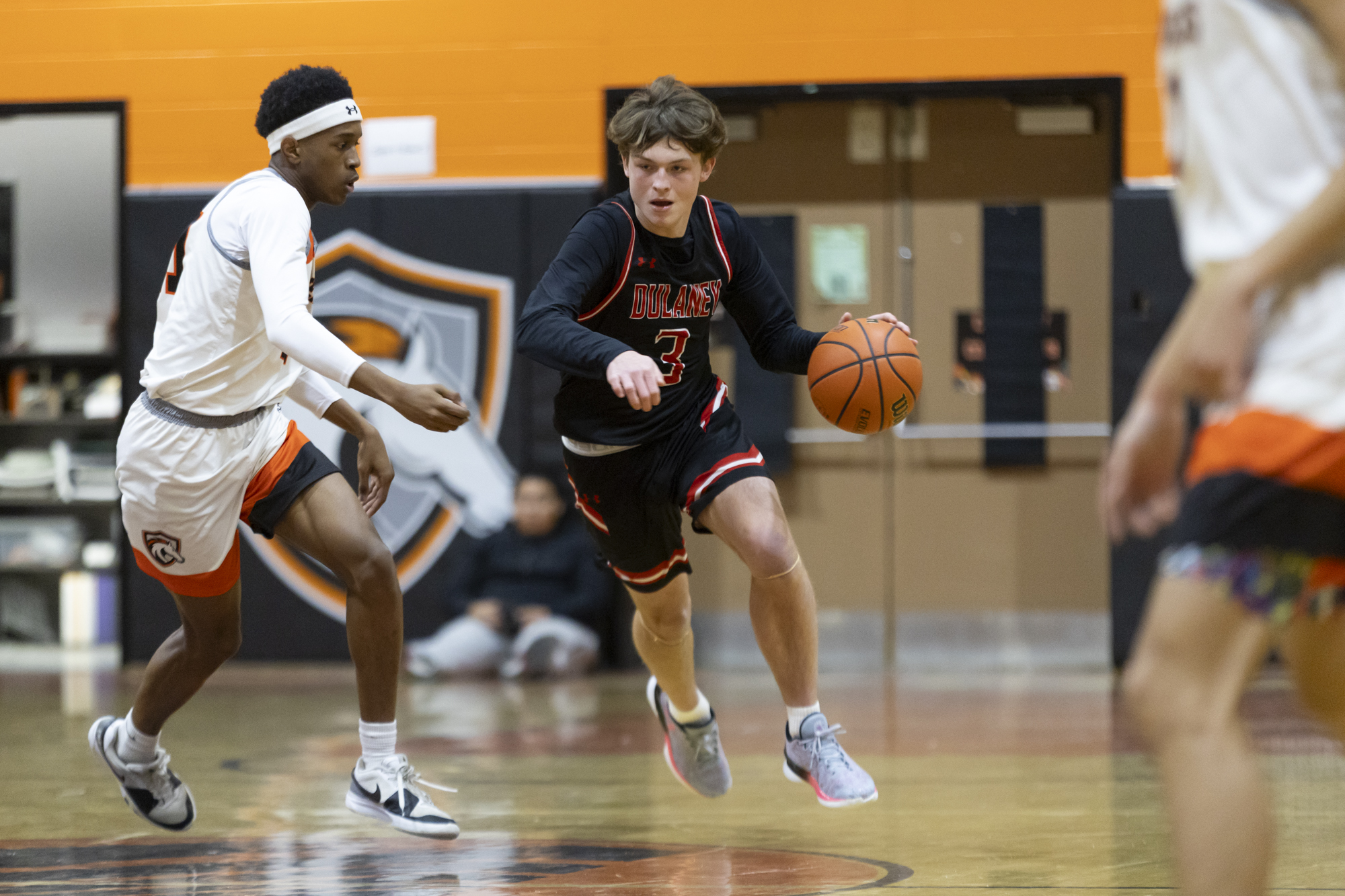 Dulaney's Chase Huber brings the ball downcourt during Friday's game...