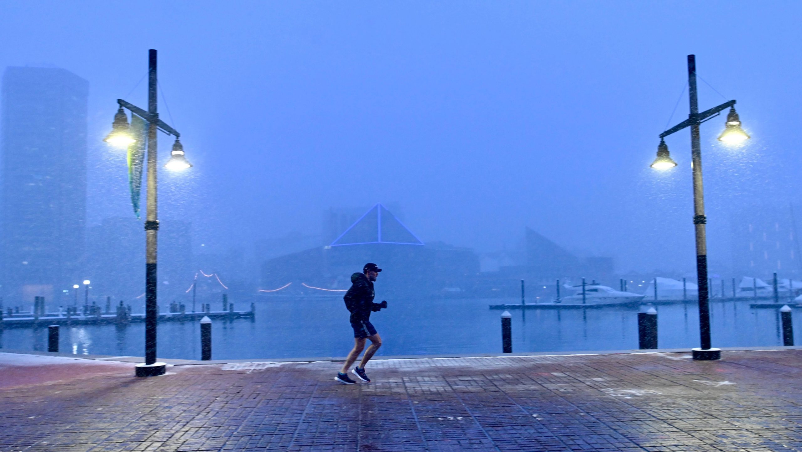 A jogger runs through the falling snow at the Inner...