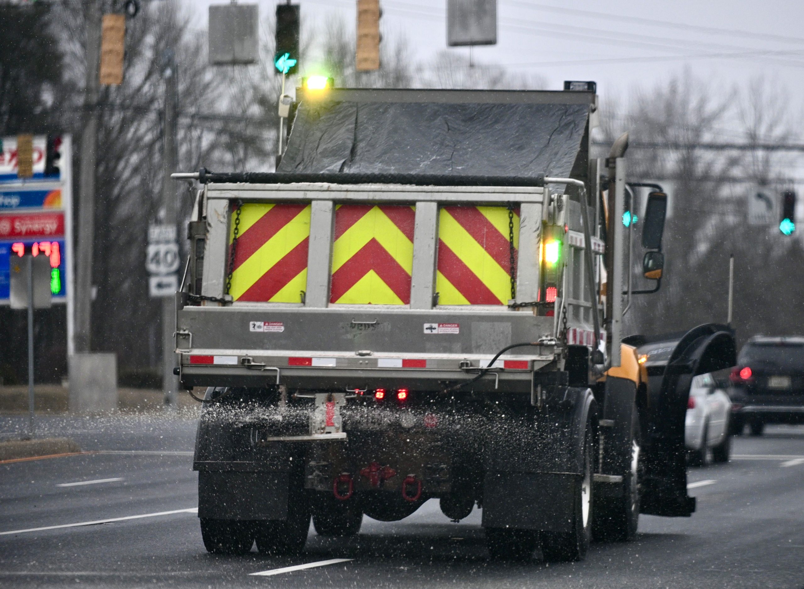 A snowplow spreads salt on Mountain Road in Joppa as...