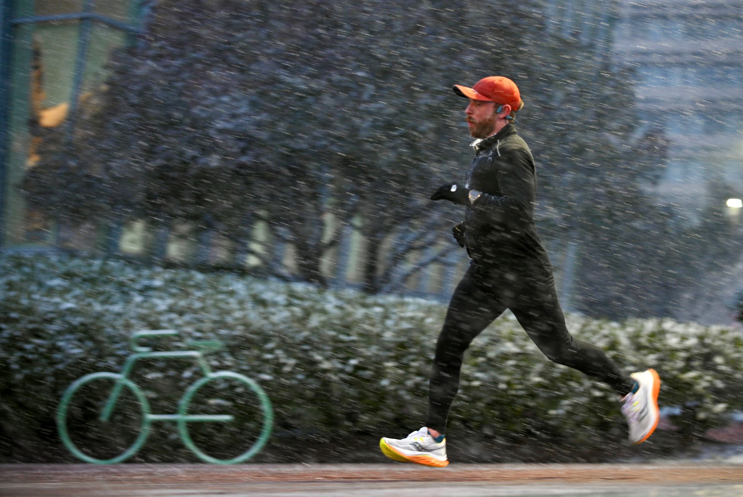 A jogger runs through the falling snow near the Maryland...