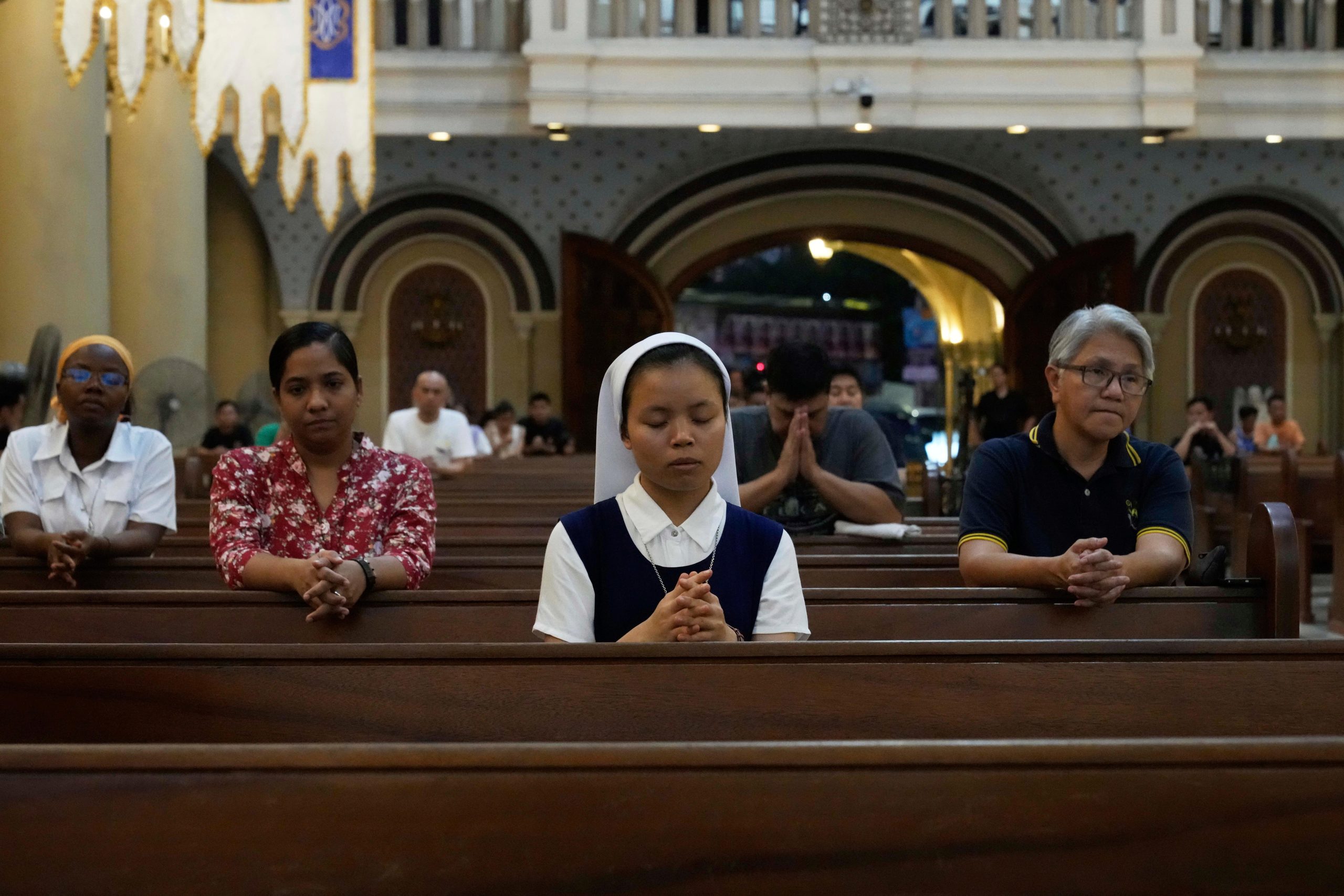 Devotees pray during a mass for the late Pope Francis...