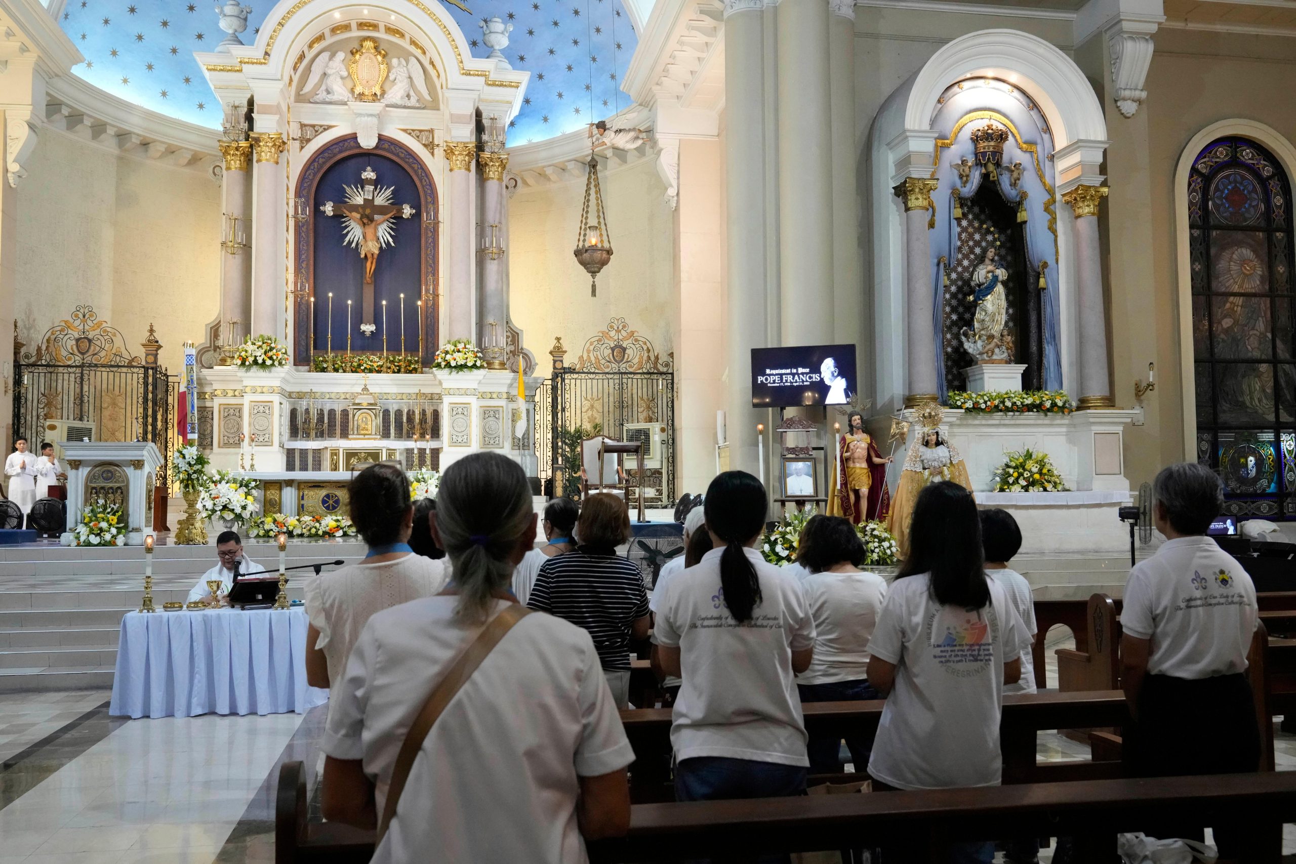Devotees pray during a mass for the late Pope Francis...