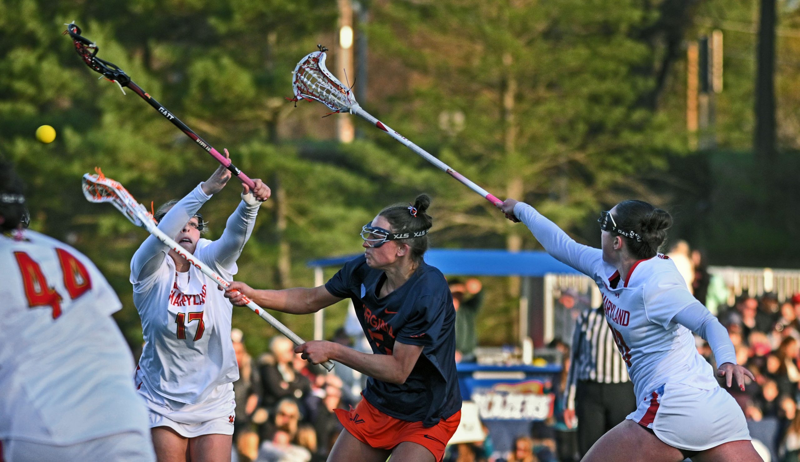 Virginia’s Kate Galica, center, splits Maryland defenders Maddy Sterling, left,...