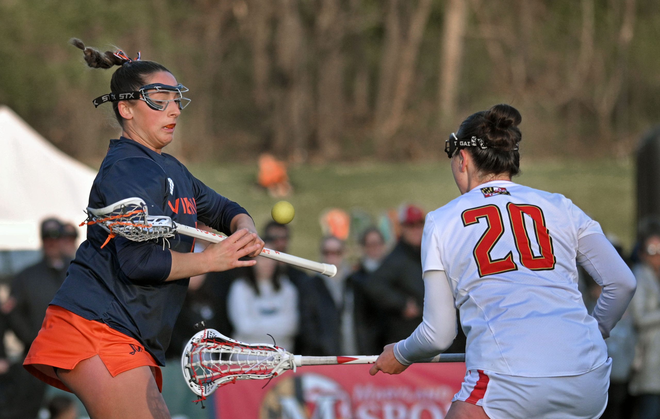 Virginia’s Jenna Dinardo, left, looses control of the ball to...