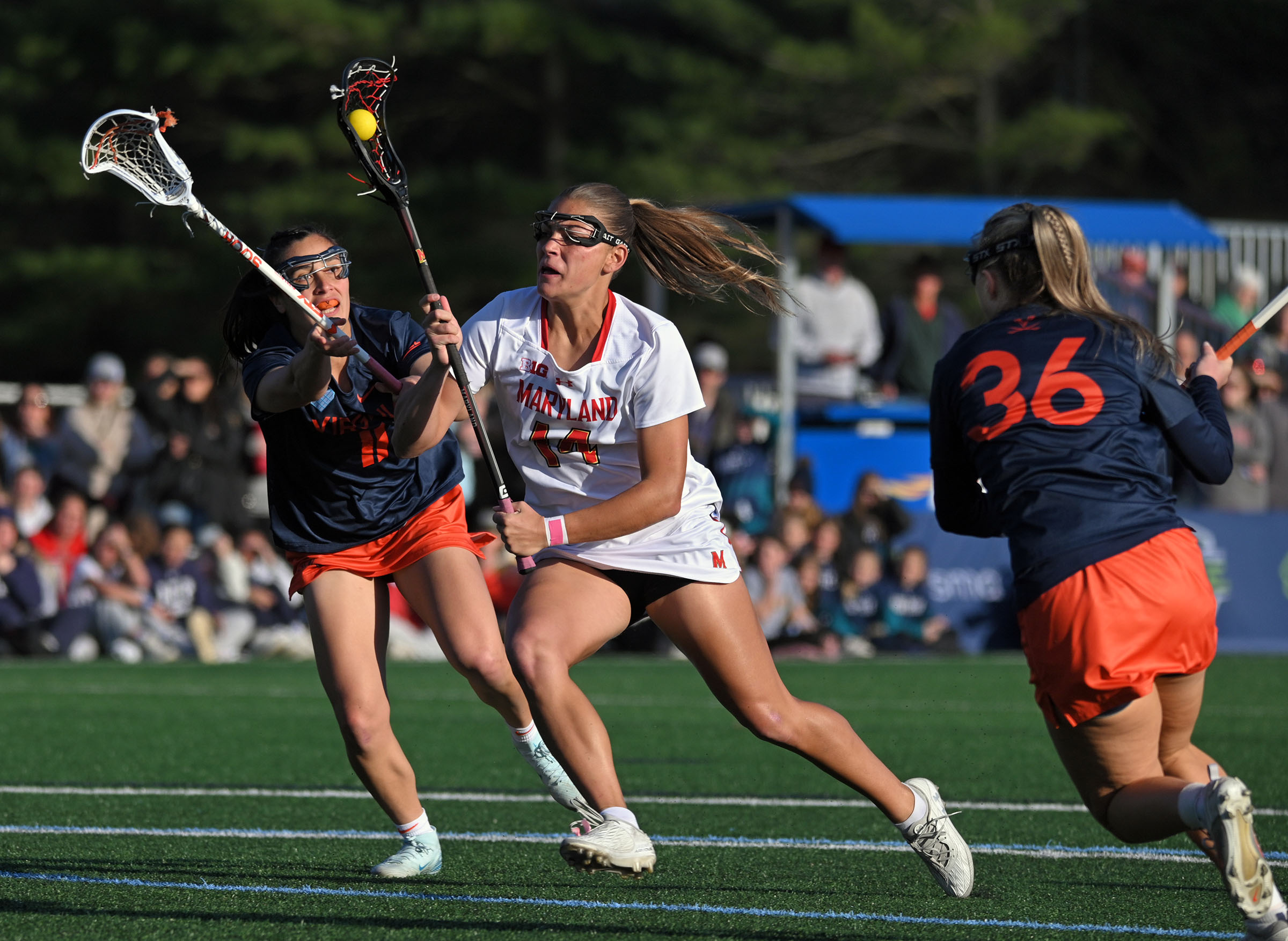 Maryland’s Kori Edmondson, center, runs past Virginia’s Abby Manalang, left,...
