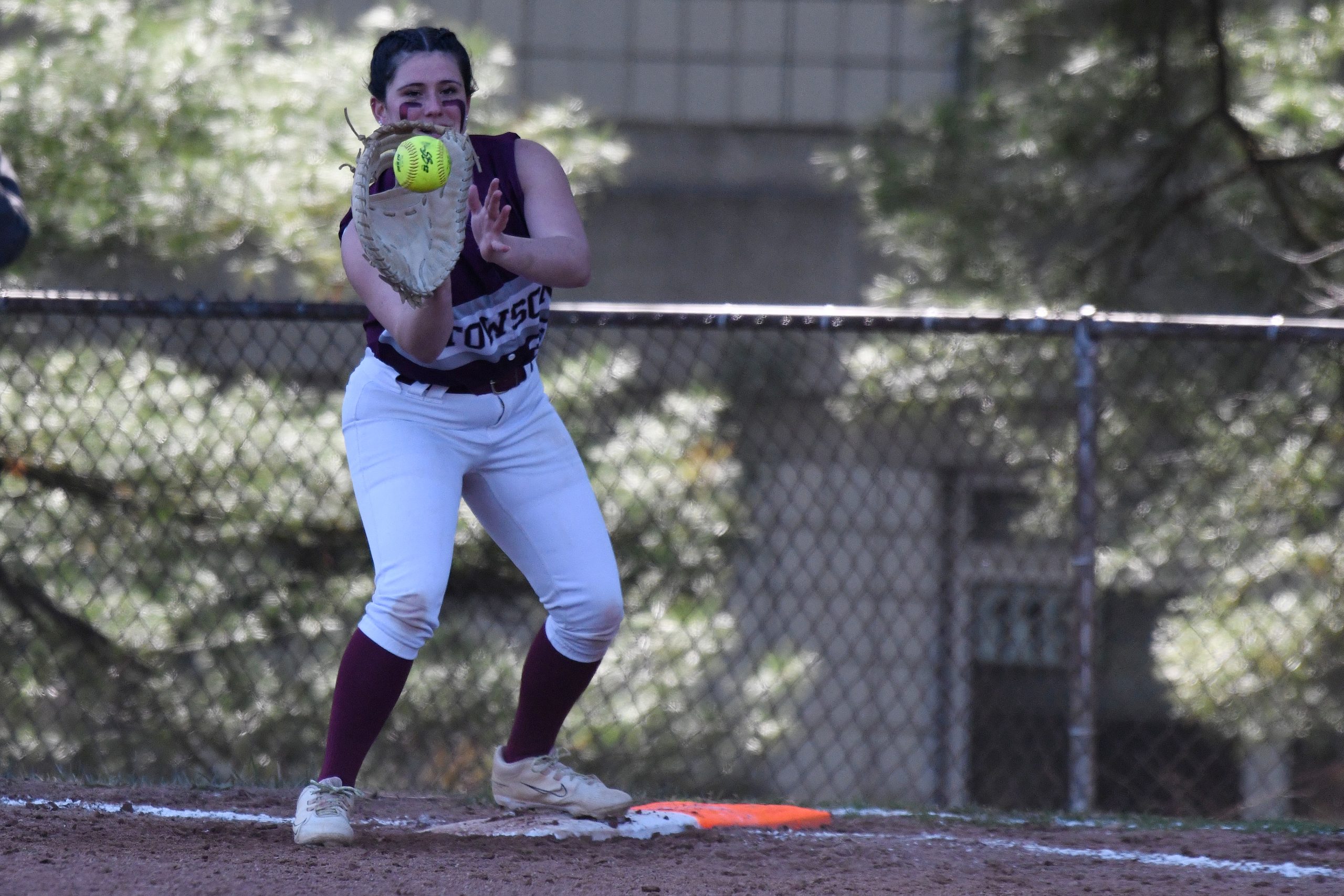 Aviva McElhenney, Towson, makes a play at first base ahead...