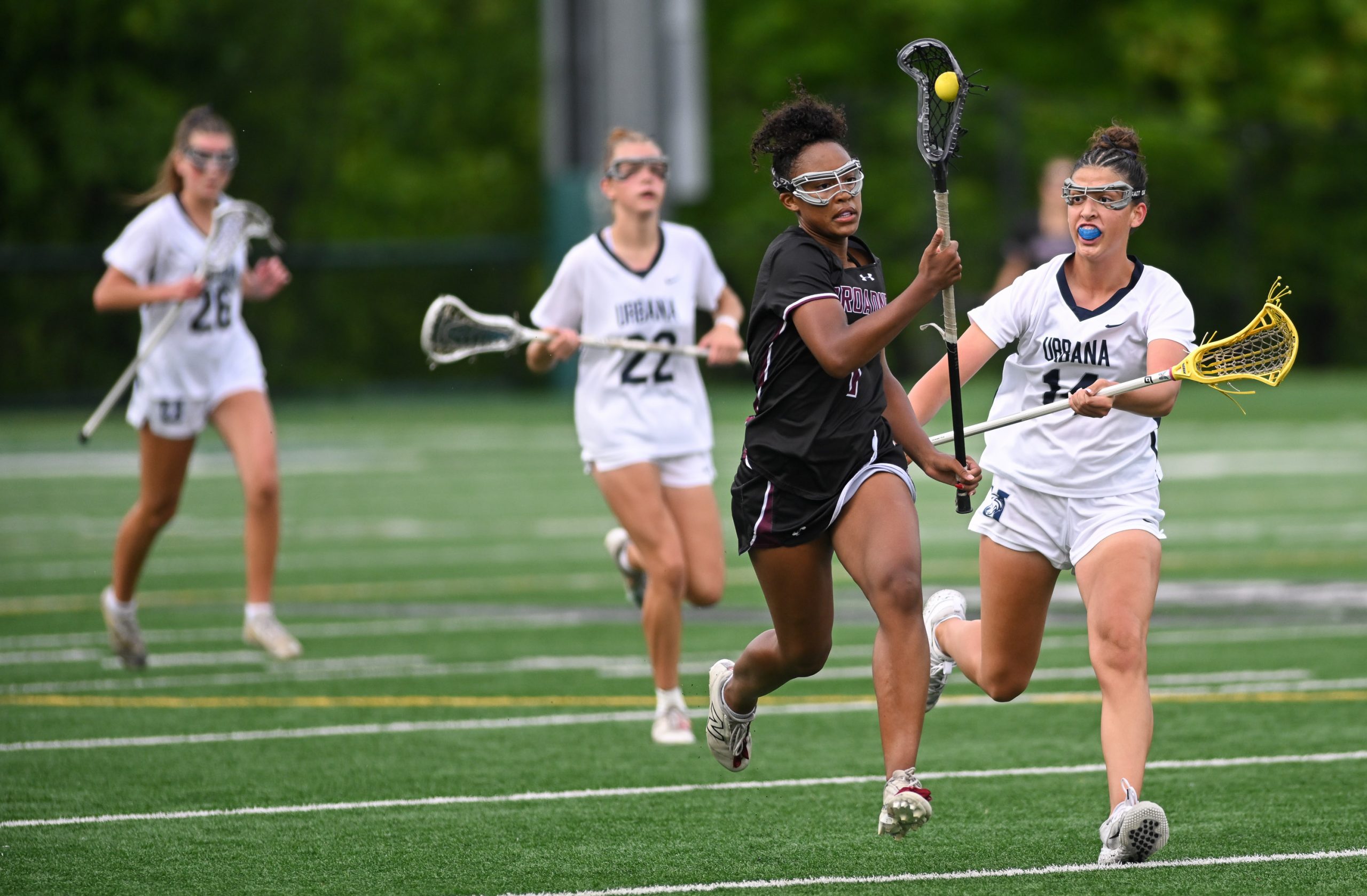 Broadneck’s Nya Williams, second from right, outruns Urbana’s Gabby Savoy,...