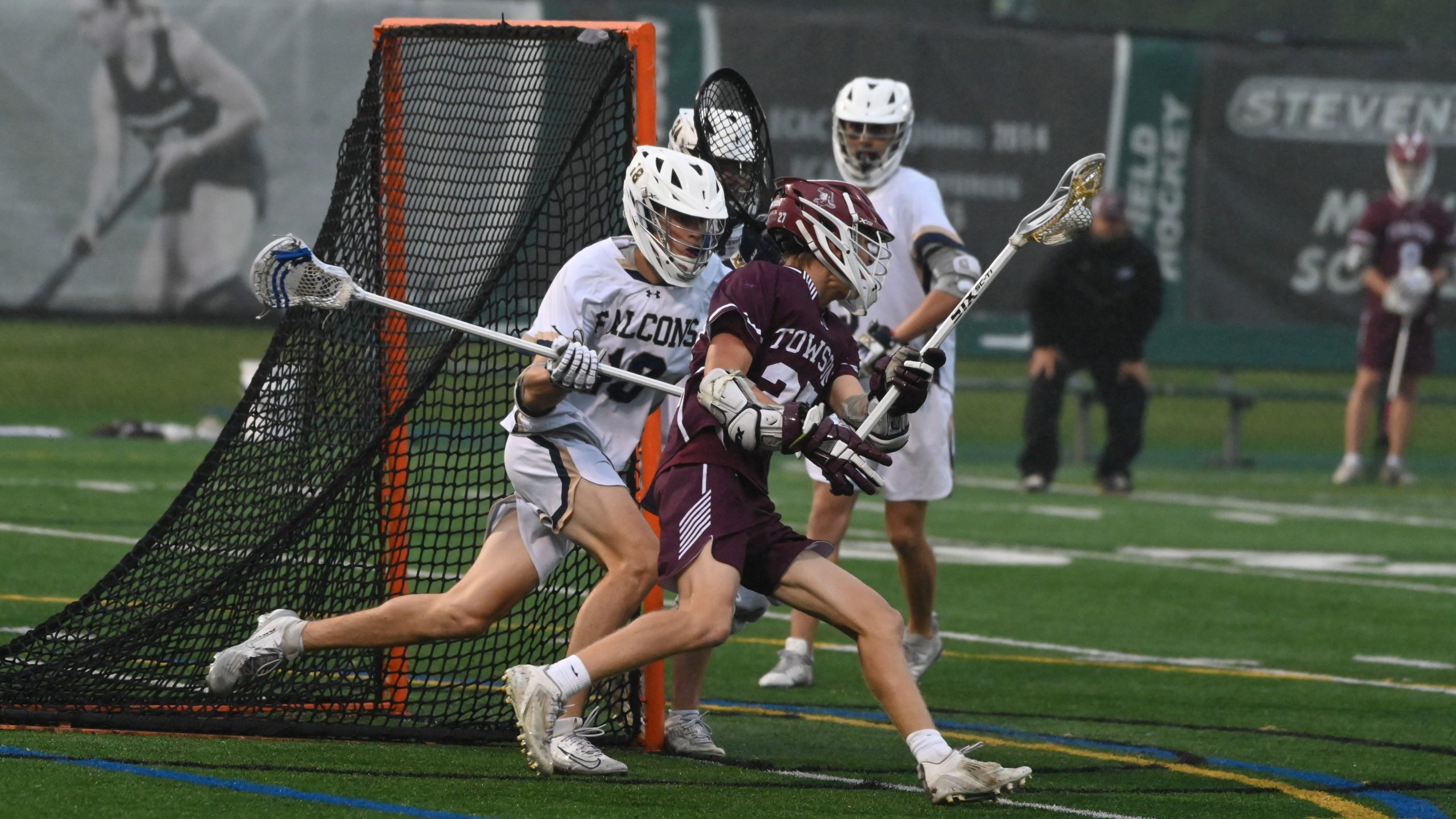 Towson’s Hudson Arrup moves around the goal and pressure from...