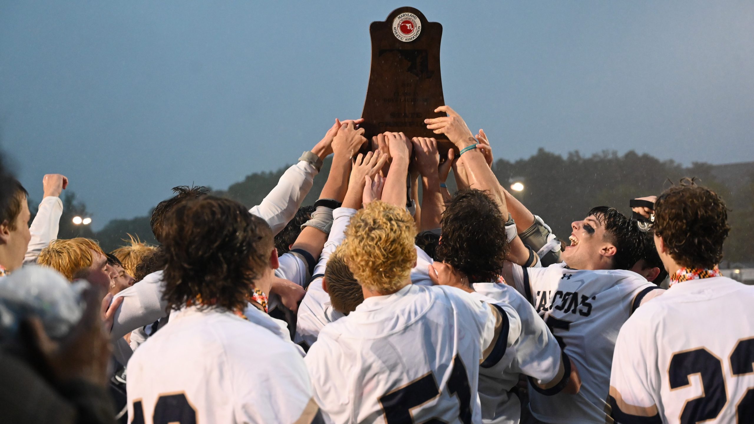 Severna Park players raise their trophy after their win over...