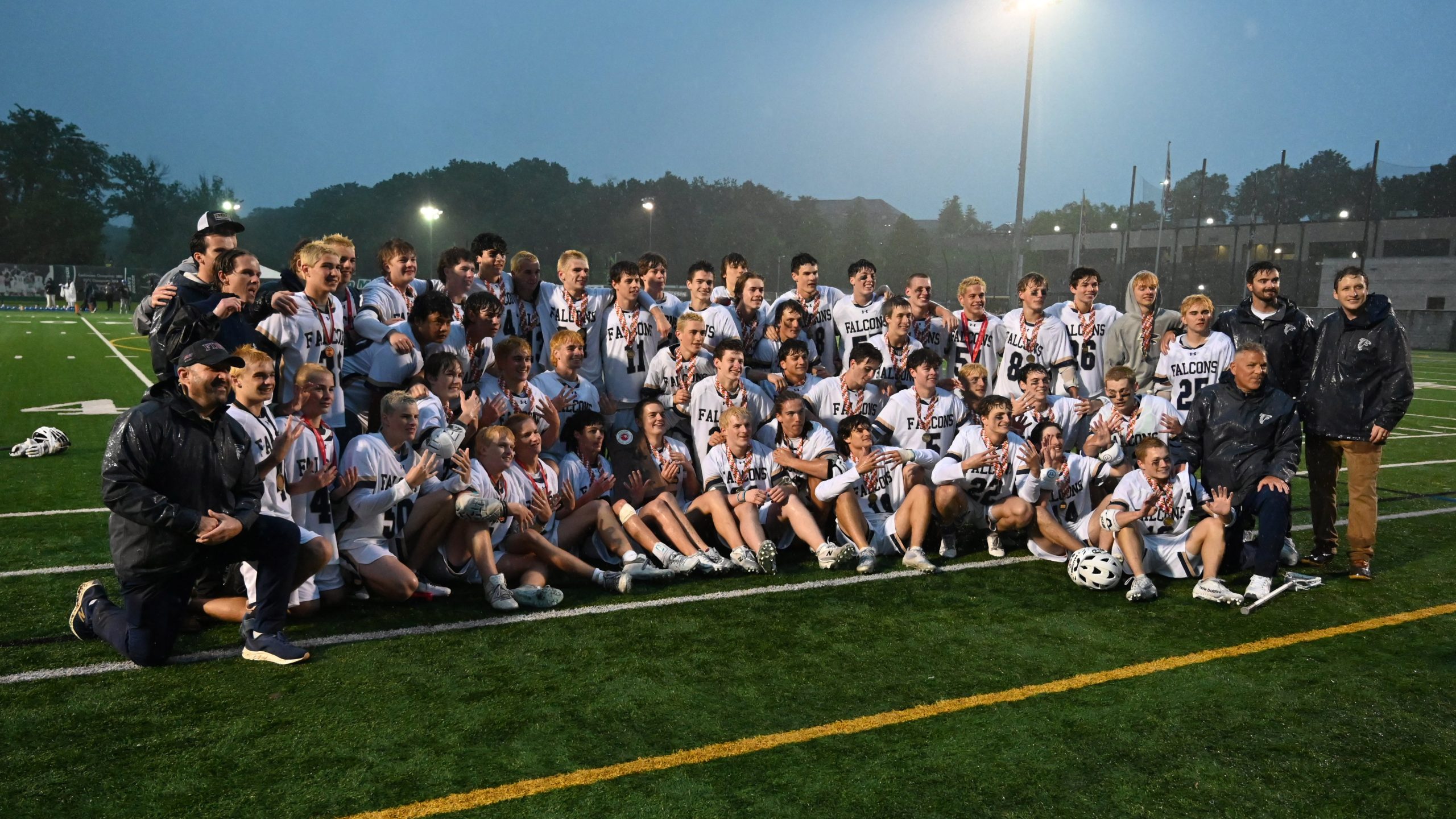 Severna Park’s boys lacrosse team poses with their trophy following...