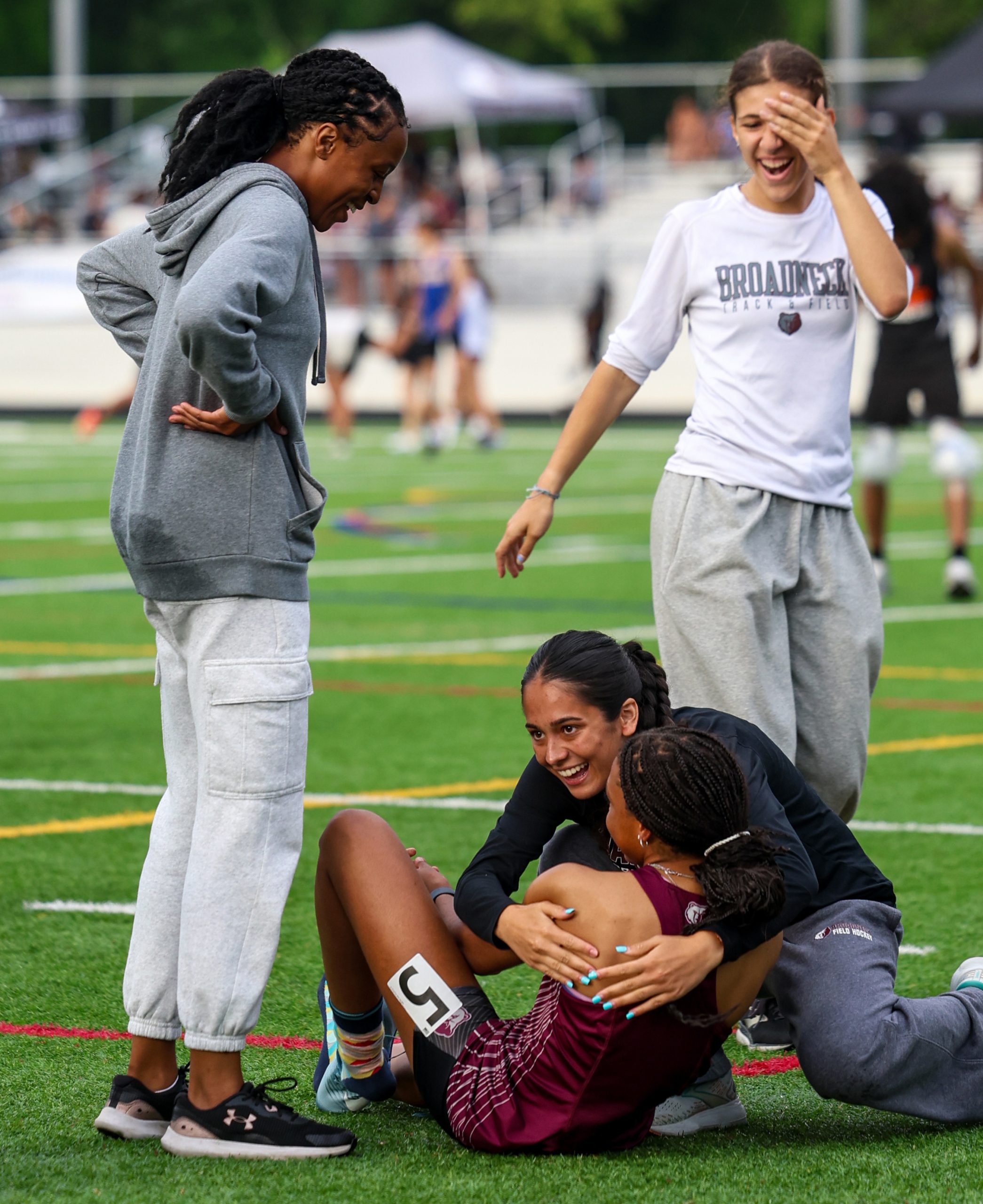 Teammates celebrate with Ashtyn Coates, Broadneck, after her 200m win....