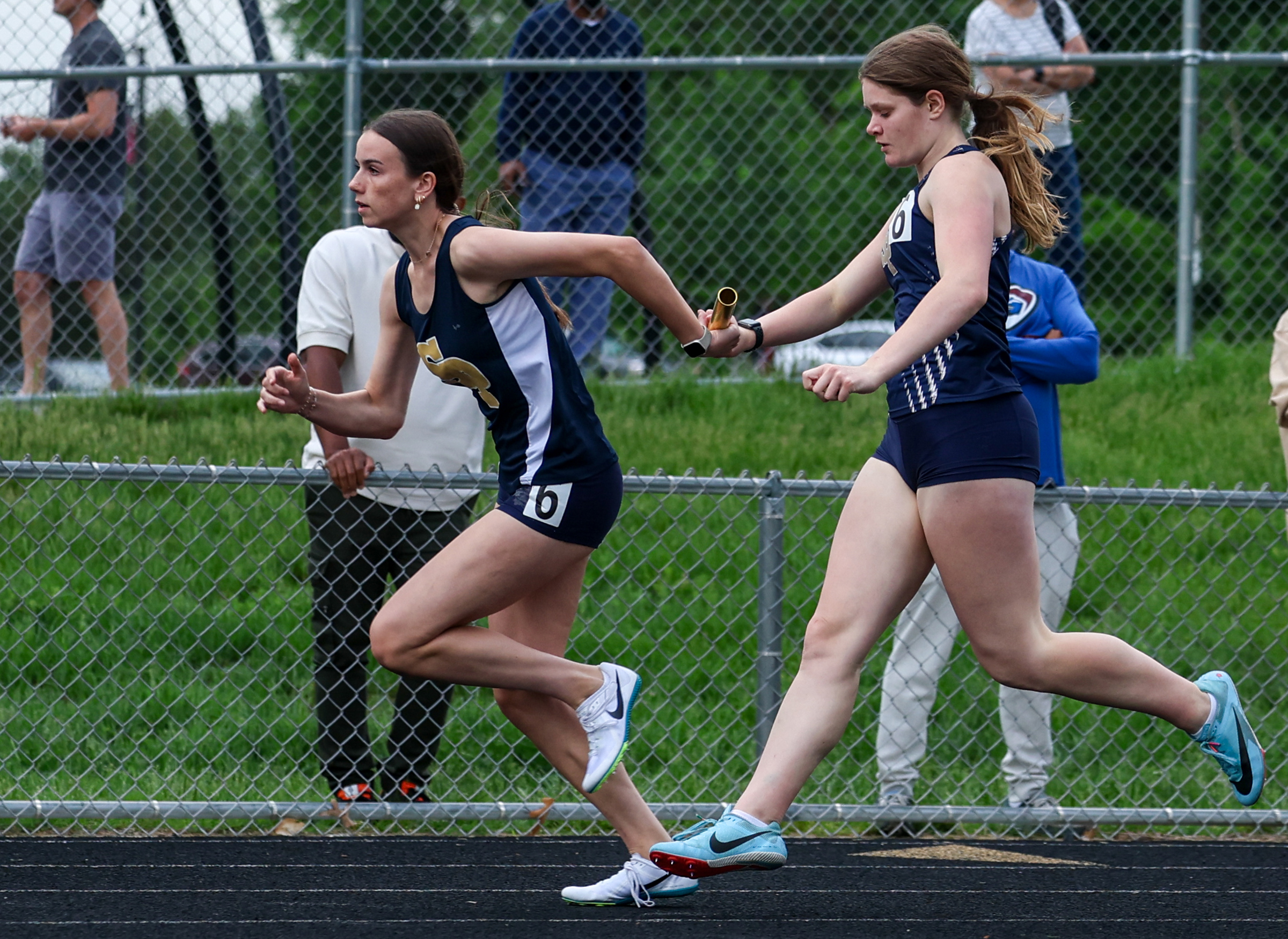 Riley McGowan hands off to Chelsea Coward in 4x100mr. Anne...