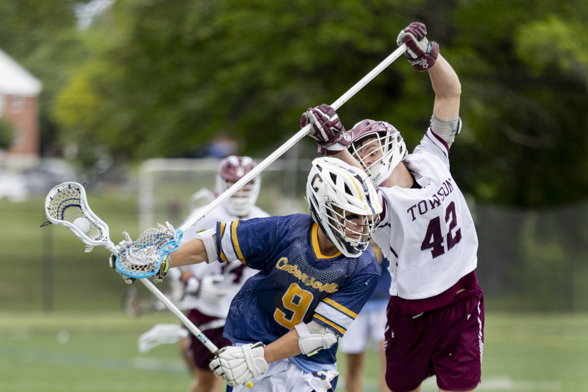 Towson’s Jack Nowlan reaches behind Colin Fox to strip the...