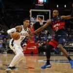 Milwaukee Bucks forward Kyle Kuzma (18) drives to the basket as Washington Wizards forward Khris Middleton (32) defends in the first half at Capital One Arena.
