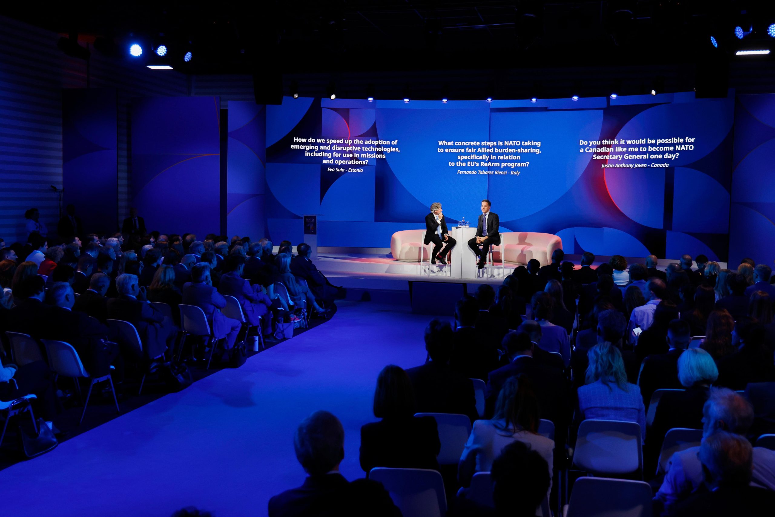 NATO Secretary General Mark Rutte, center right, addresses the audience...