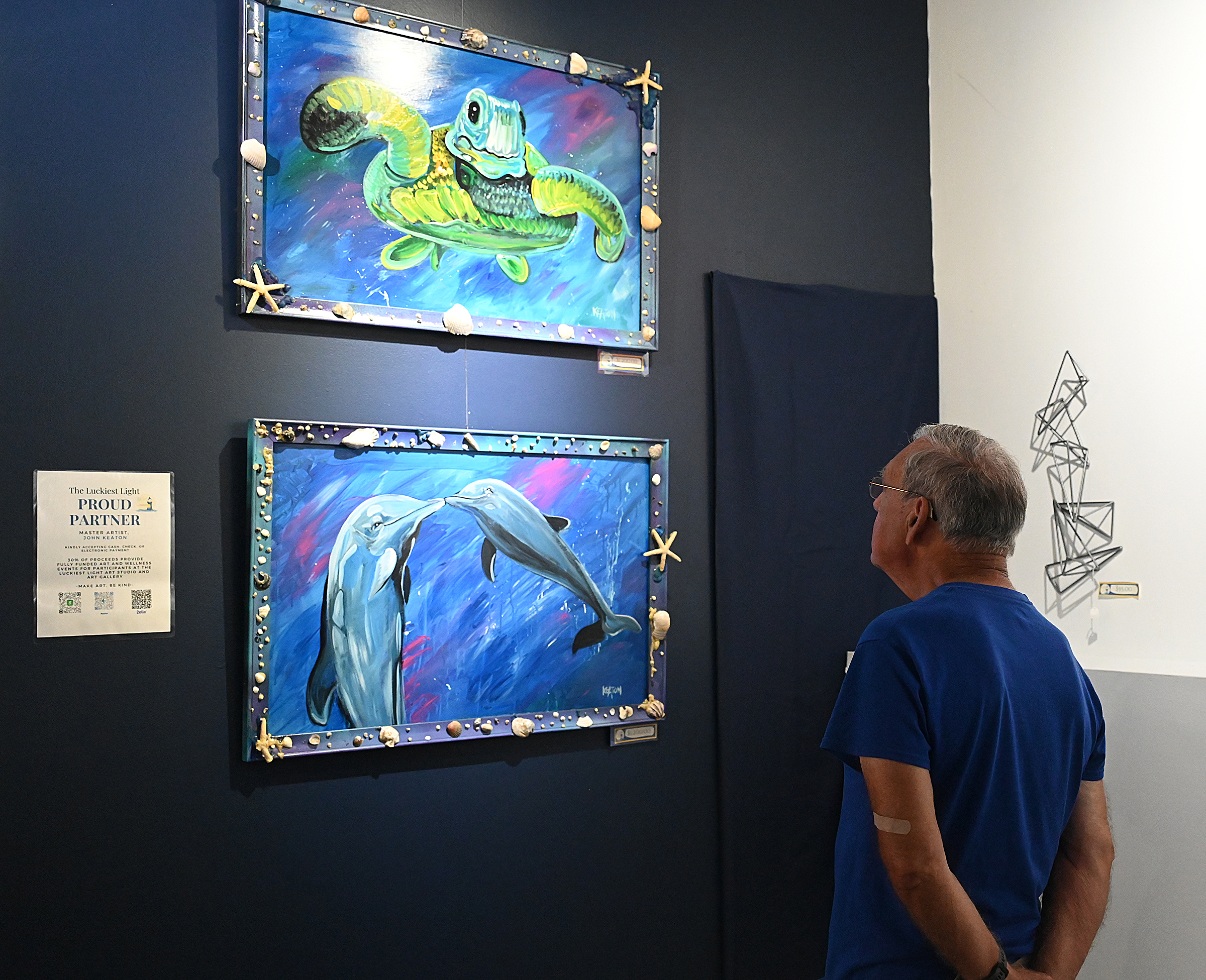 Charlie Dougherty looks at paintings by artist John Keaton. The...