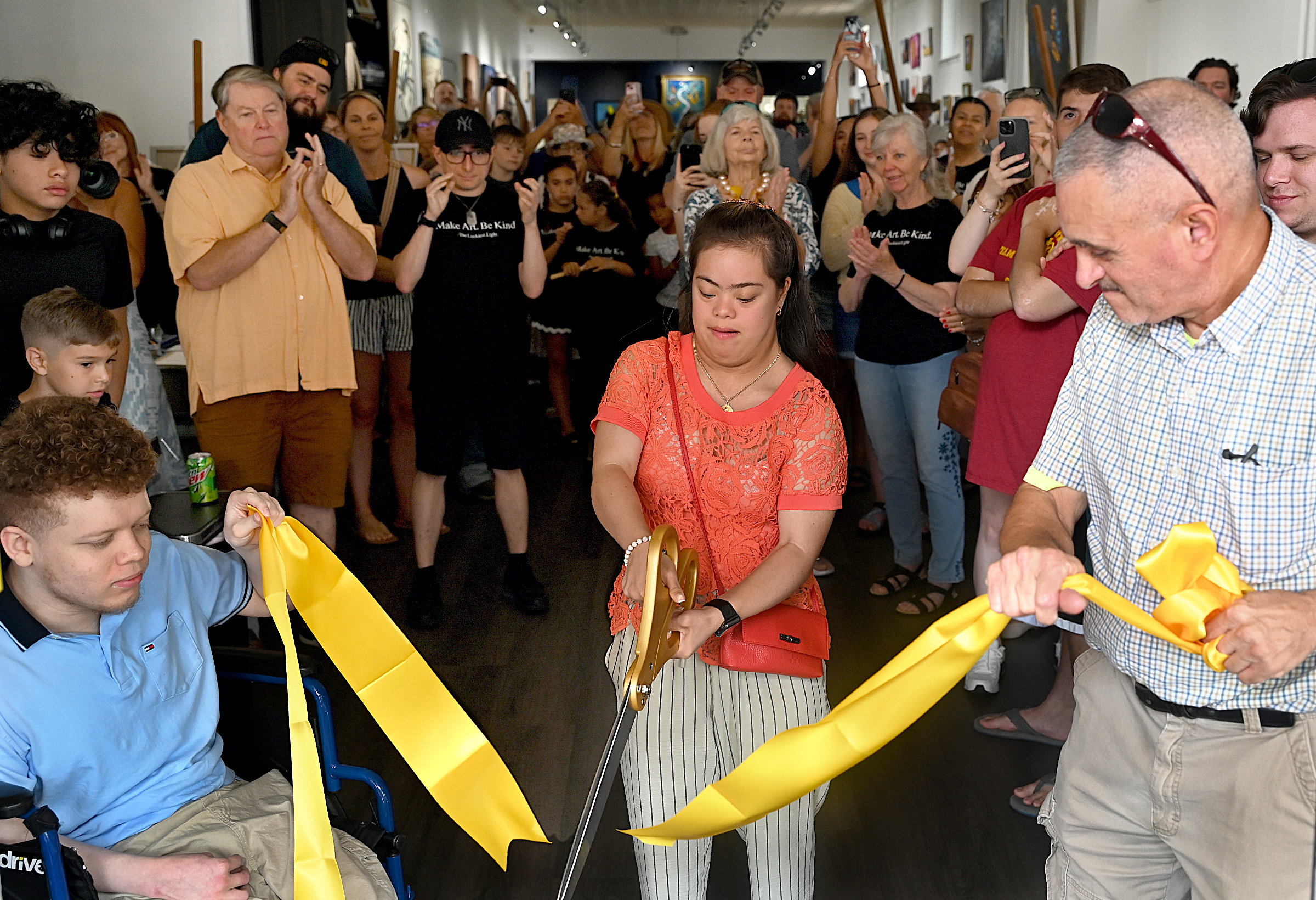 Jay McBay, left, and Joe Harter, right, hold the ribbon...
