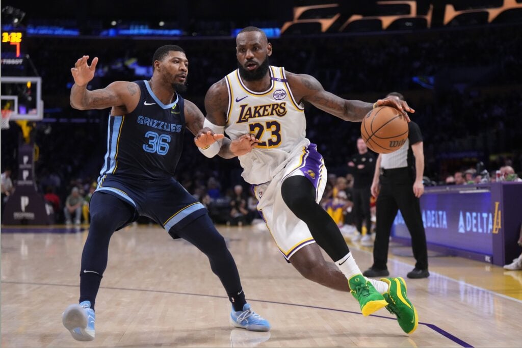 Dec 15, 2024; Los Angeles, California, USA; Los Angeles Lakers forward LeBron James (23) dribbles the ball against Memphis Grizzlies guard Marcus Smart (36) at Crypto.com Arena. Mandatory Credit: Kirby Lee-Imagn Images