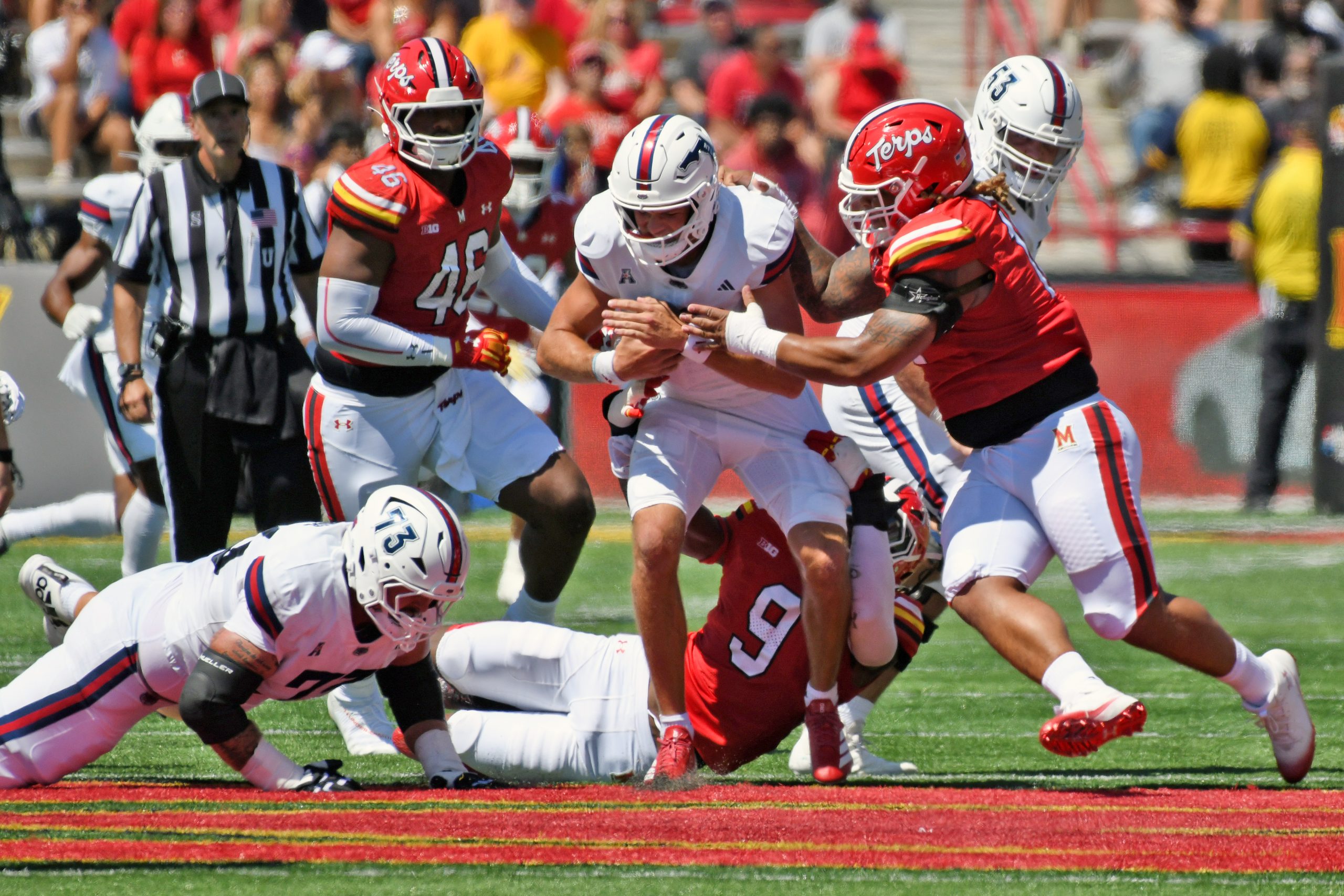 Maryland’s Zahir Mathis holds up Florida Atlantic quarterback Caden Veltkamp...