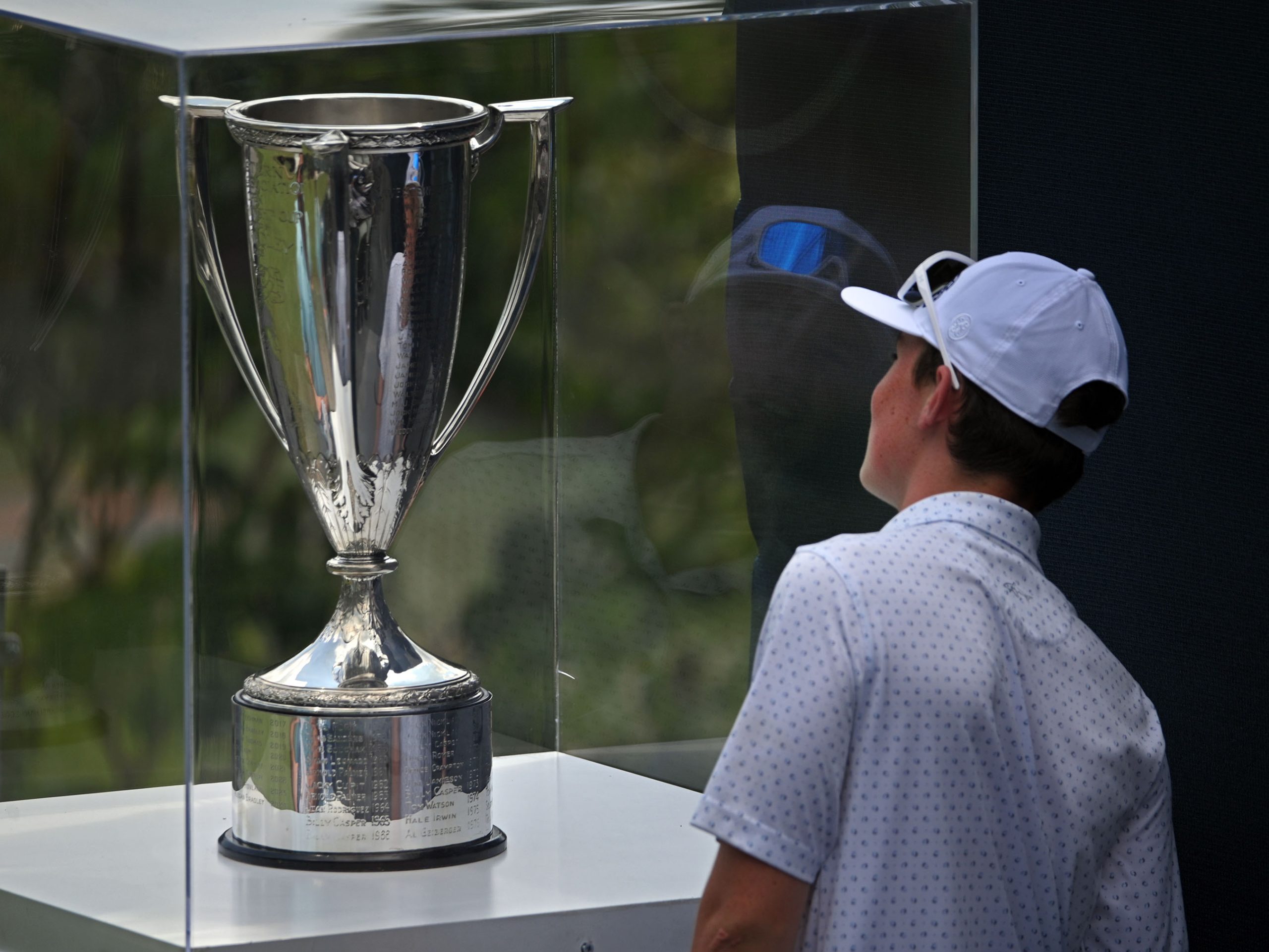 A fan checks out the championship trophy during the second...