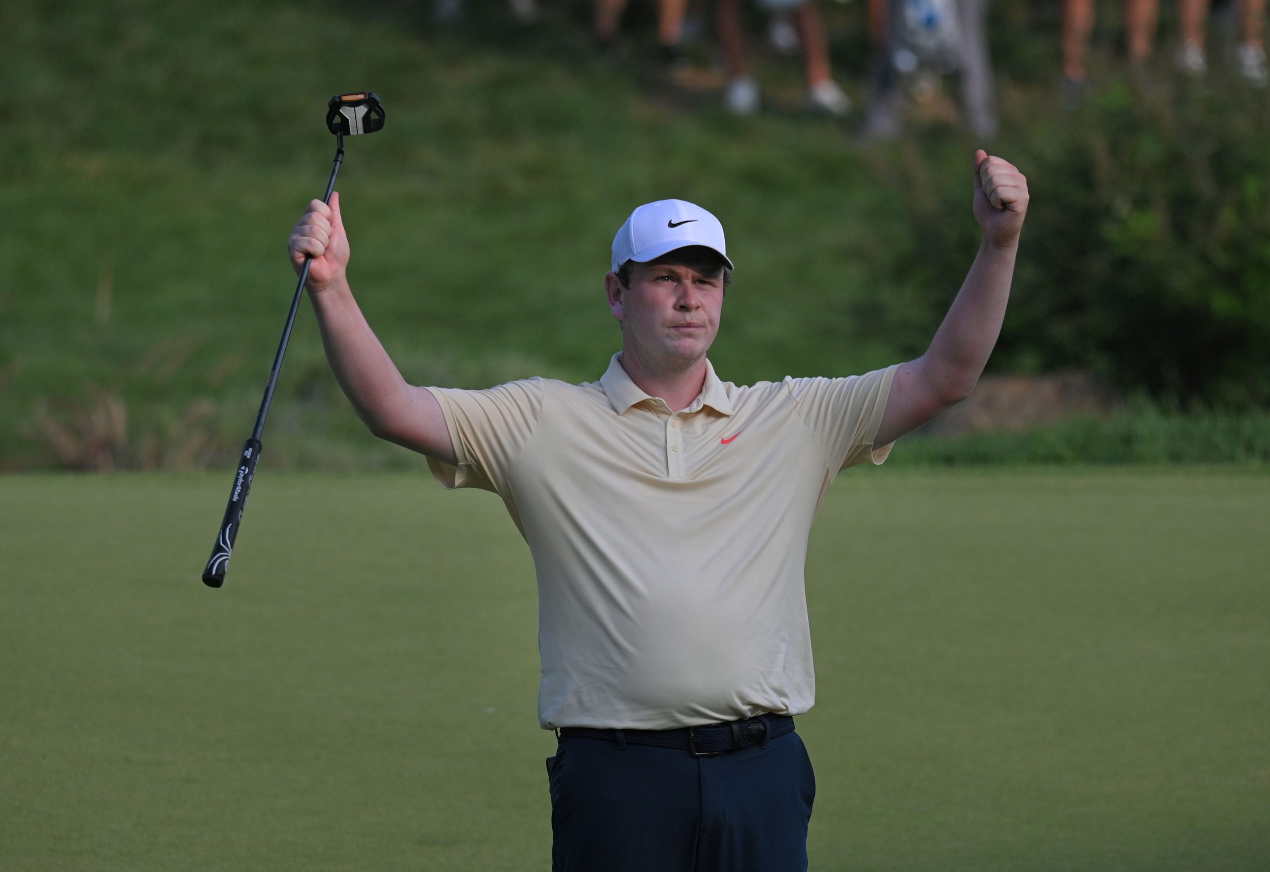 Robert MacIntyre celebrates after making a birdie on the 18th...