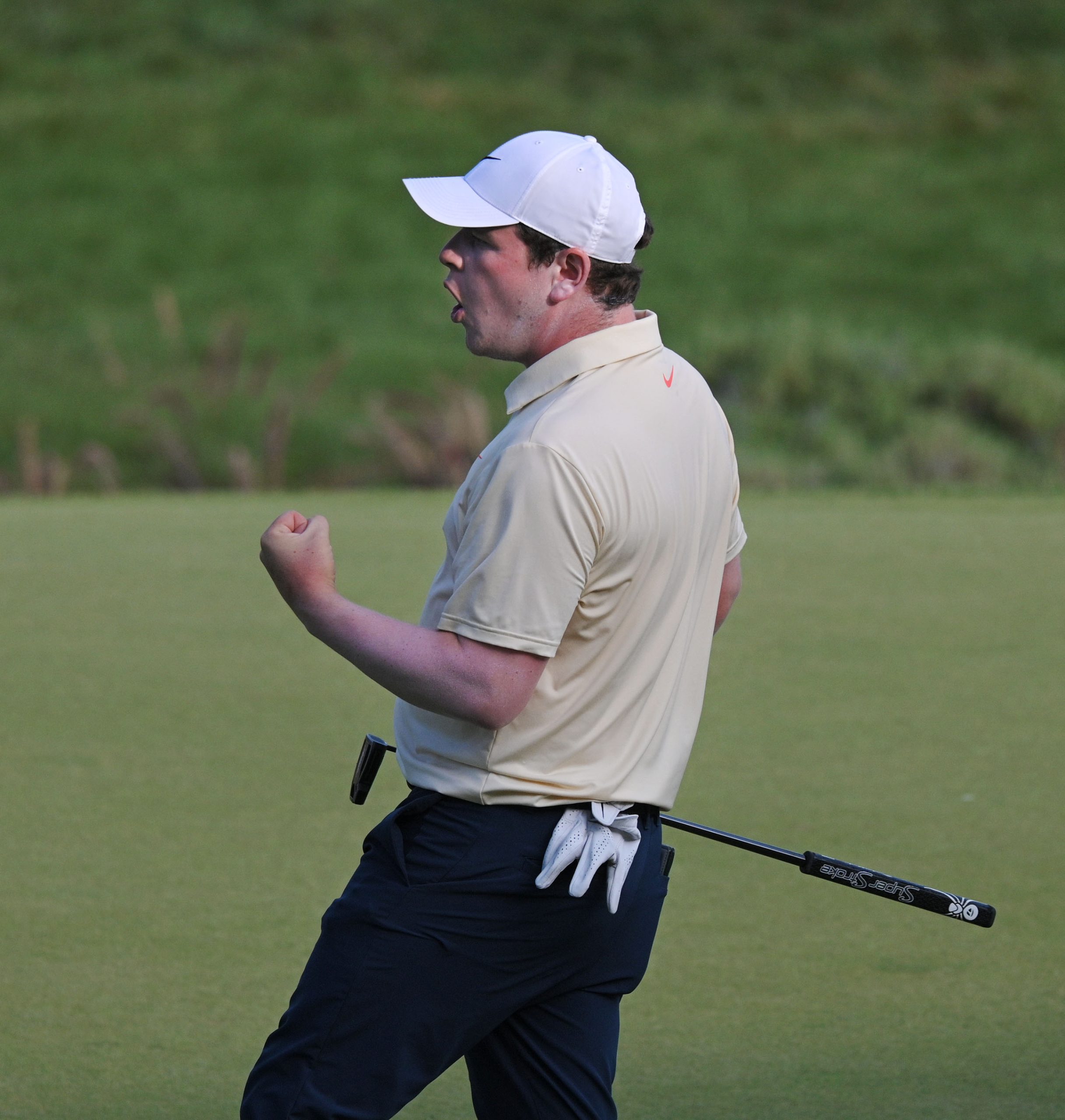 Leader Robert MacIntyre pumps his fist after a 41 foot...