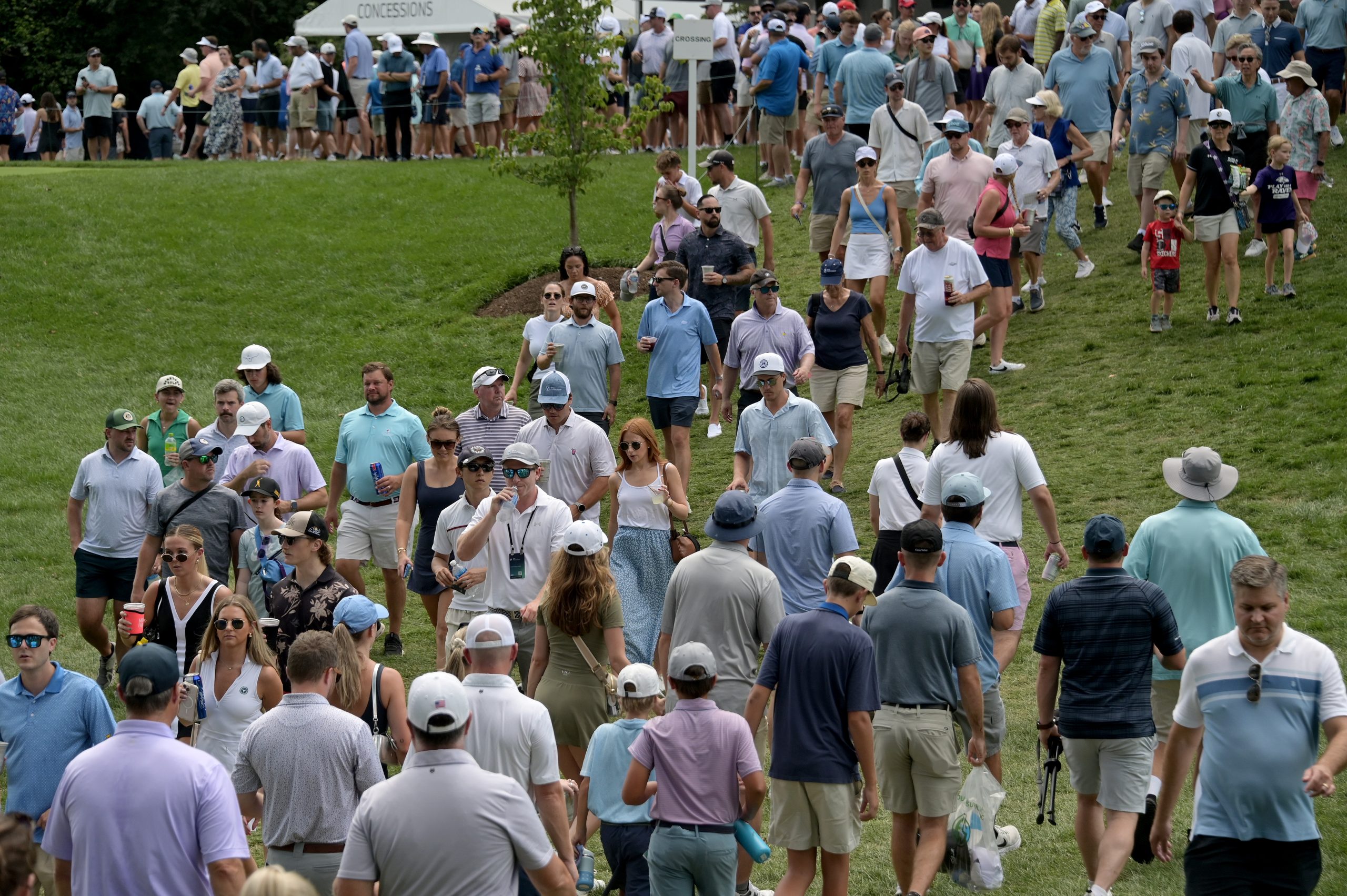 People cross near the 1st tee during the third round...