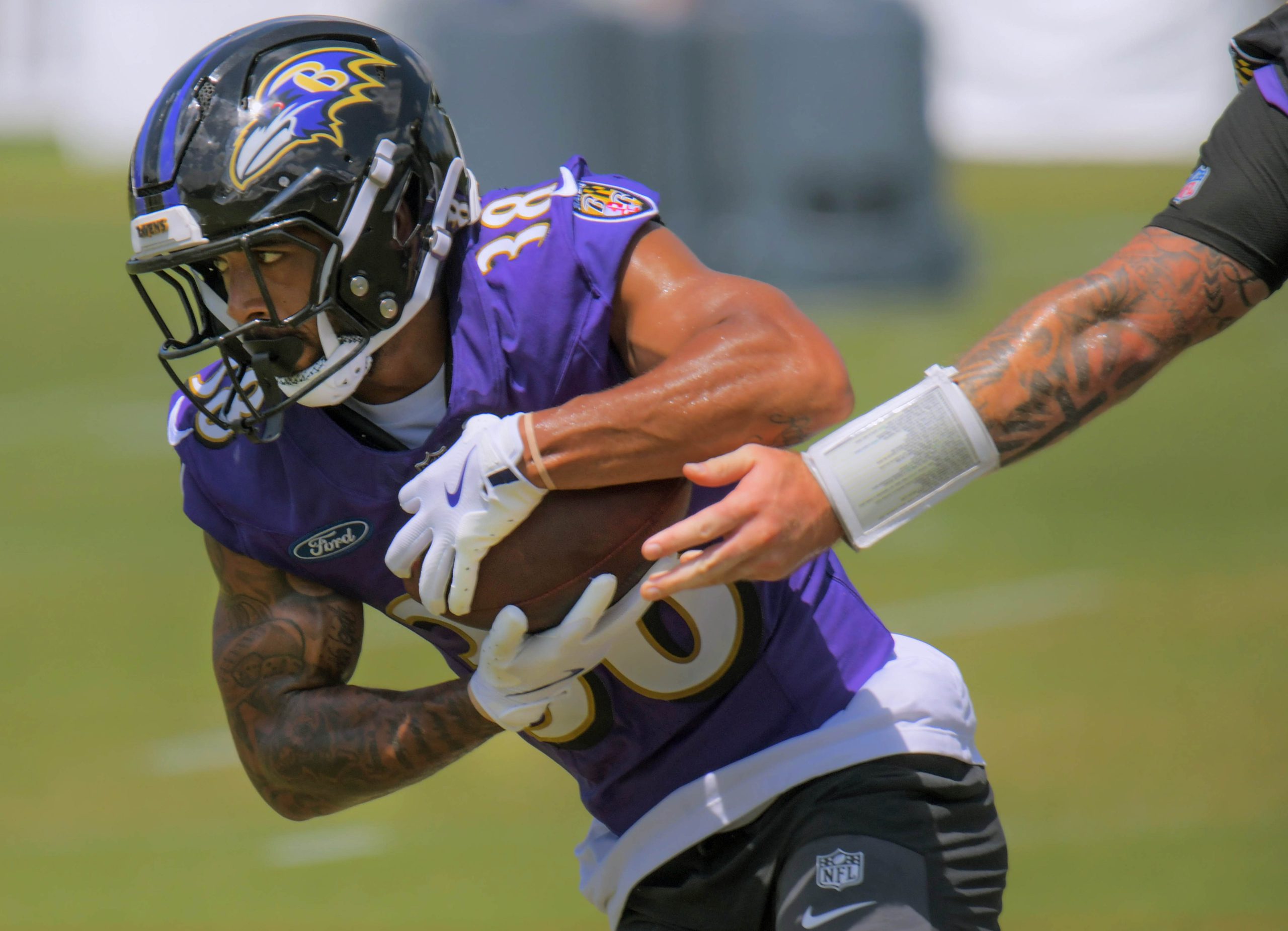 Baltimore Ravens running back Myles Gaskin receives a handoff from...