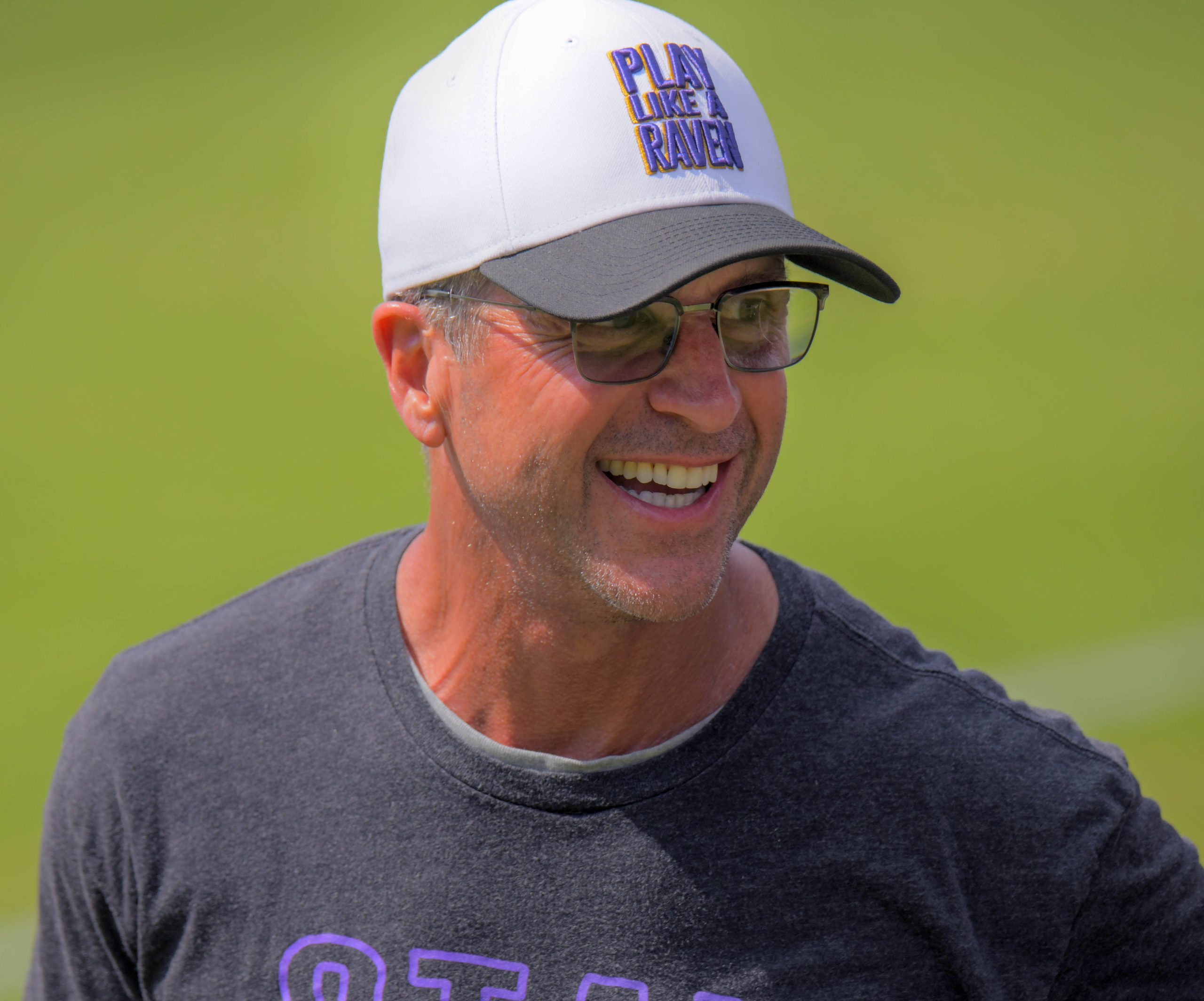Baltimore Ravens head football coach John Harbaugh smiles during practice...