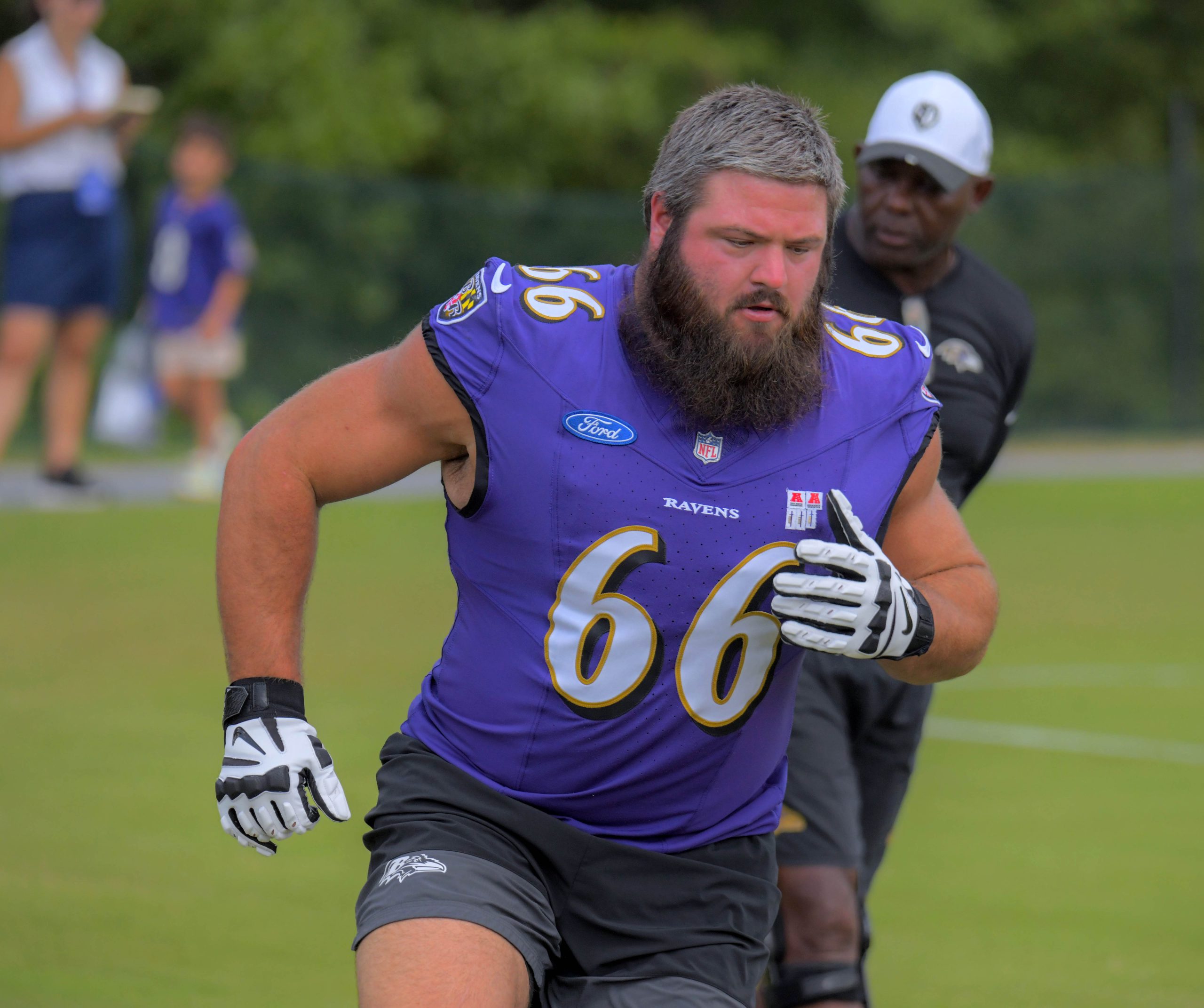 Baltimore Ravens guard Ben Cleveland zig zags in front of...