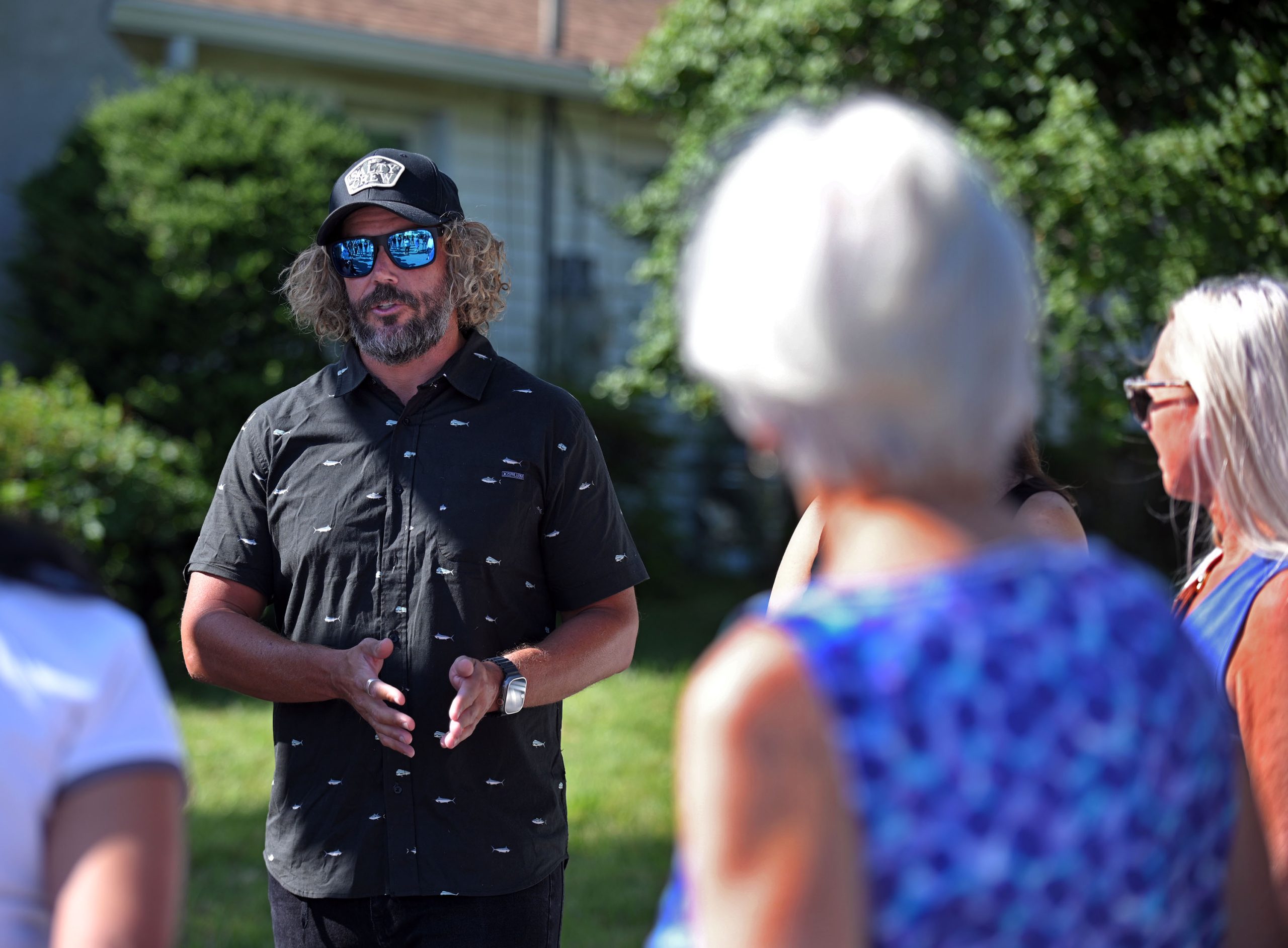 Towson resident Brendan Medairy, from left, talks about rat damages...