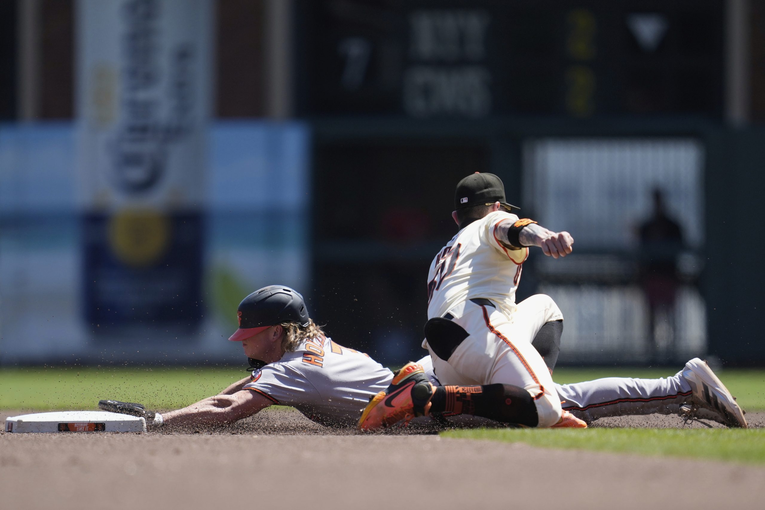 Baltimore Orioles' Jackson Holliday, bottom, steals second base against San...