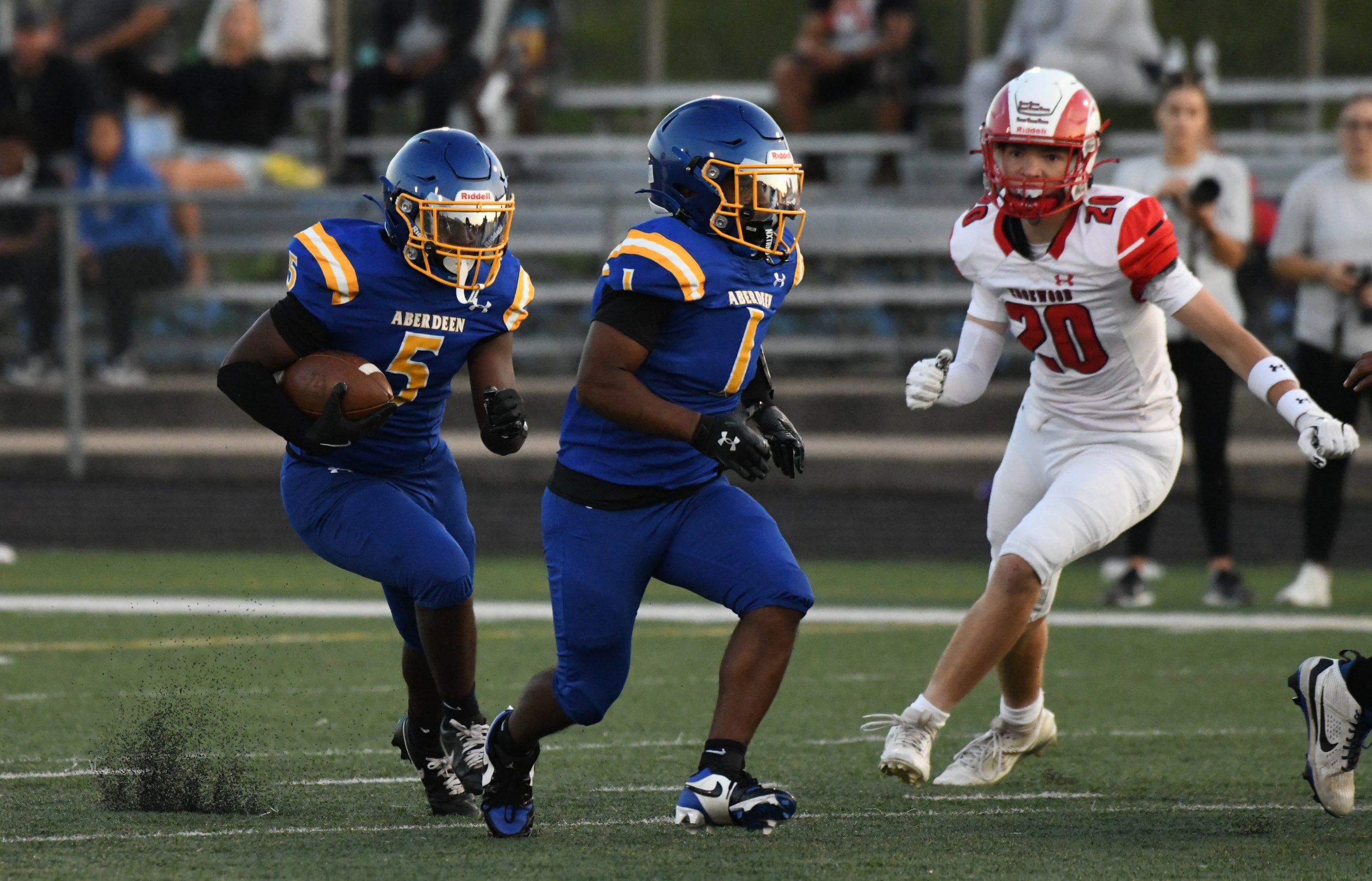 Aberdeen's Cameron Durbin carries the ball behind the block of...