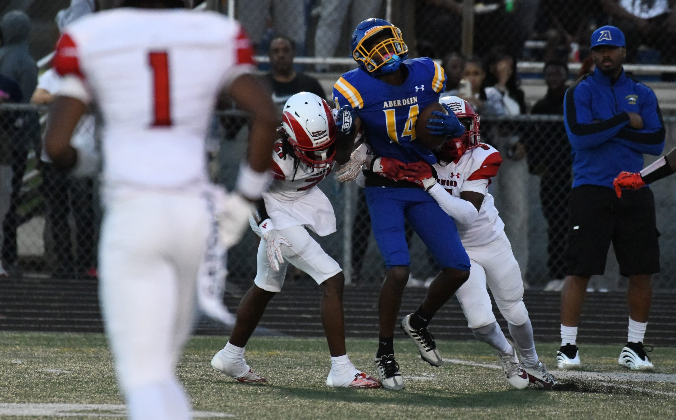 Aberdeen's Javon Kenion hangs onto the ball as Edgewood's Charles...
