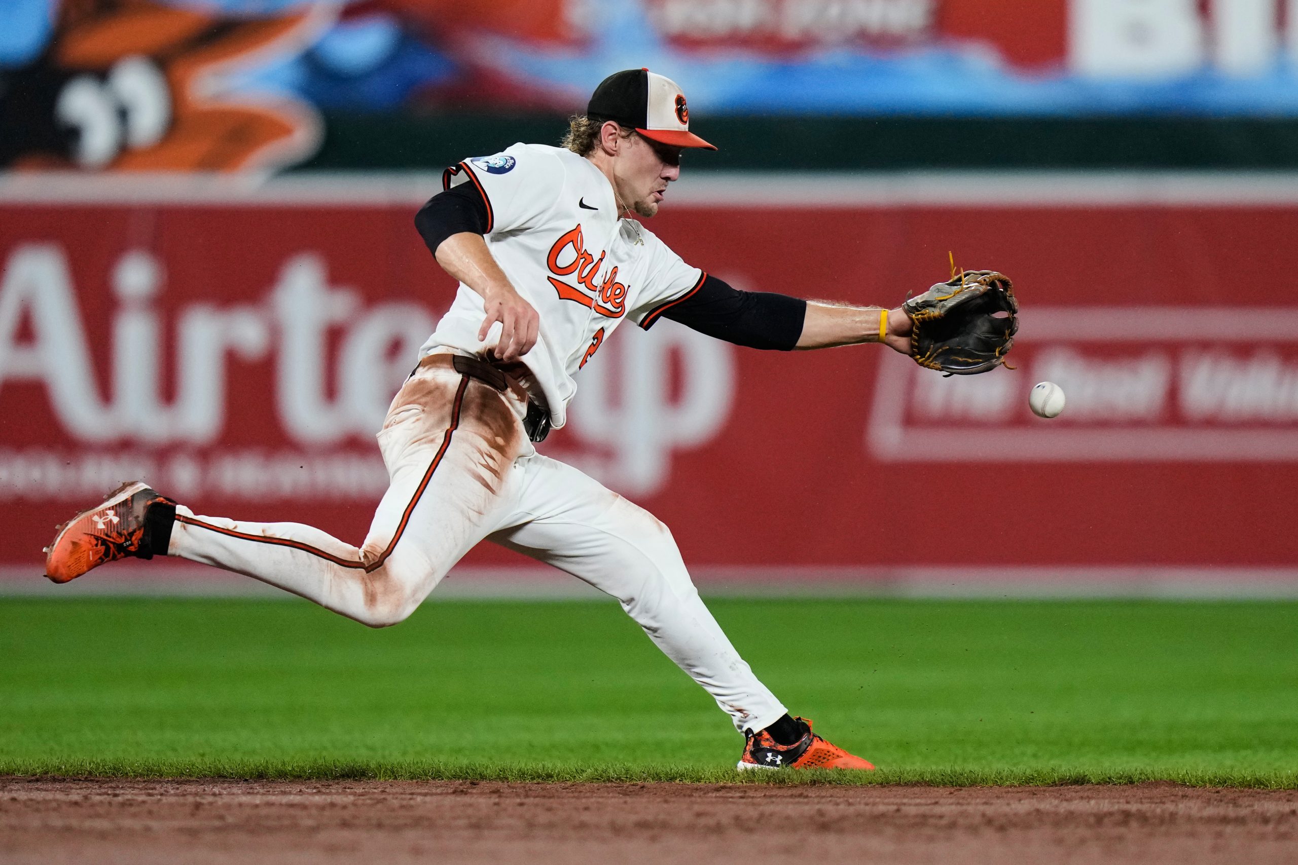 Baltimore Orioles shortstop Gunnar Henderson is unable to stop a...