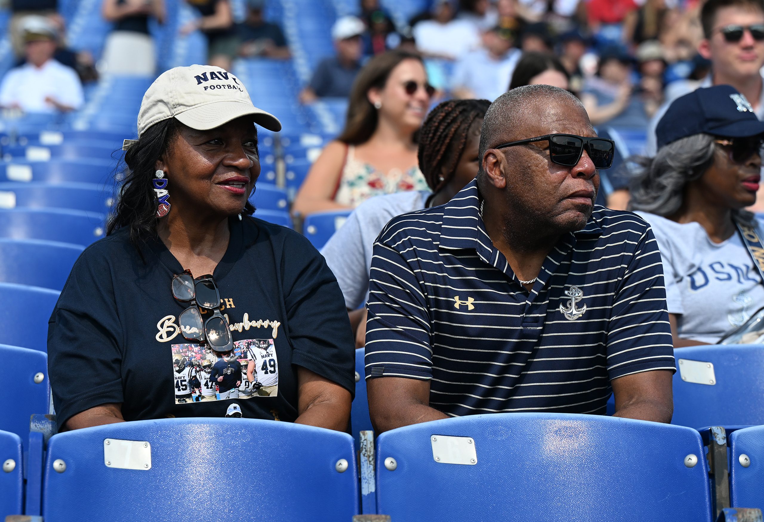 Fans watch the midshipmen during the March-On. Midshipmen march into...