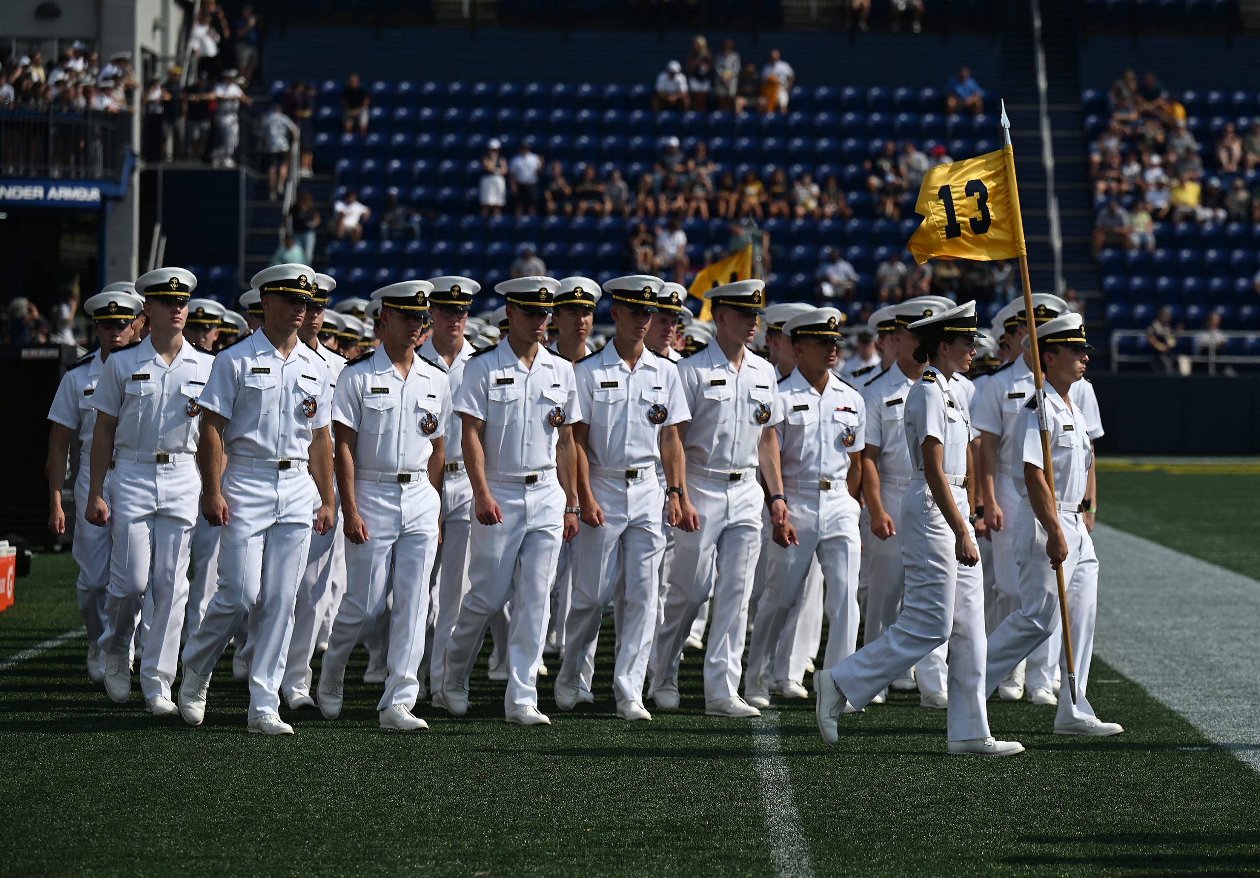 Midshipmen march into the stadium during the March-On. The Navy...