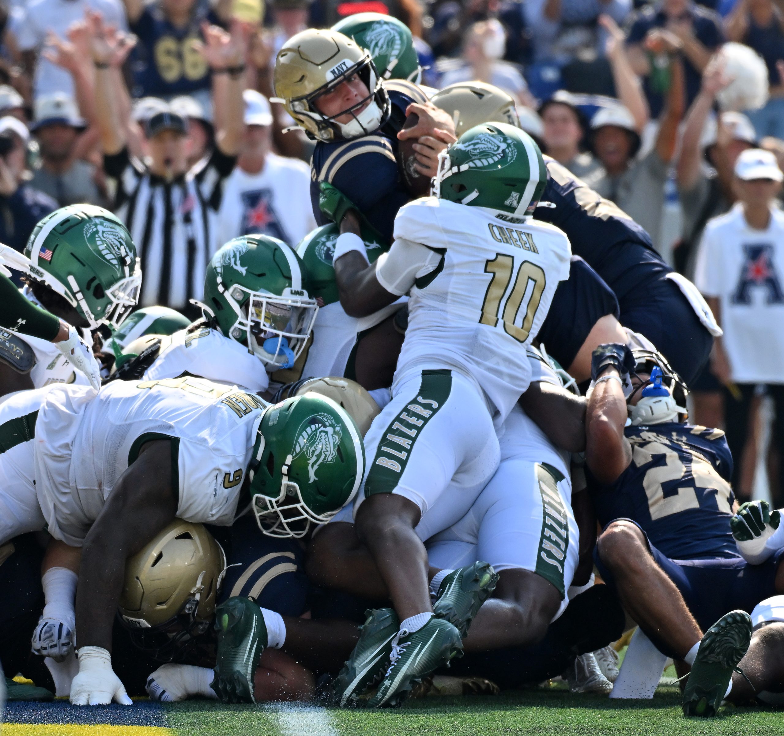 Navy quarterback Blake Horvath runs the ball in for a...