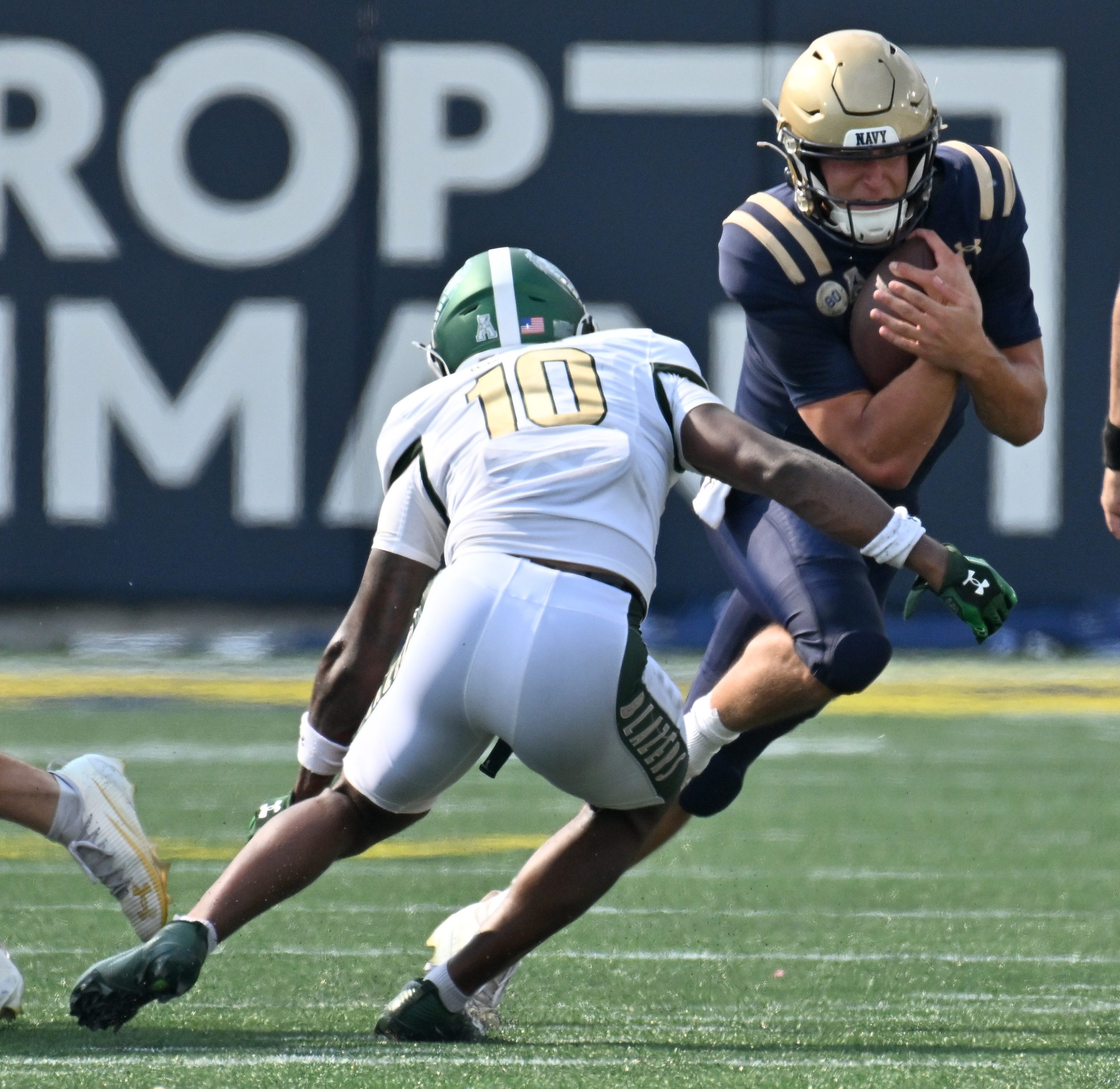 Navy quarterback Blake Horvath runs the ball in the first...