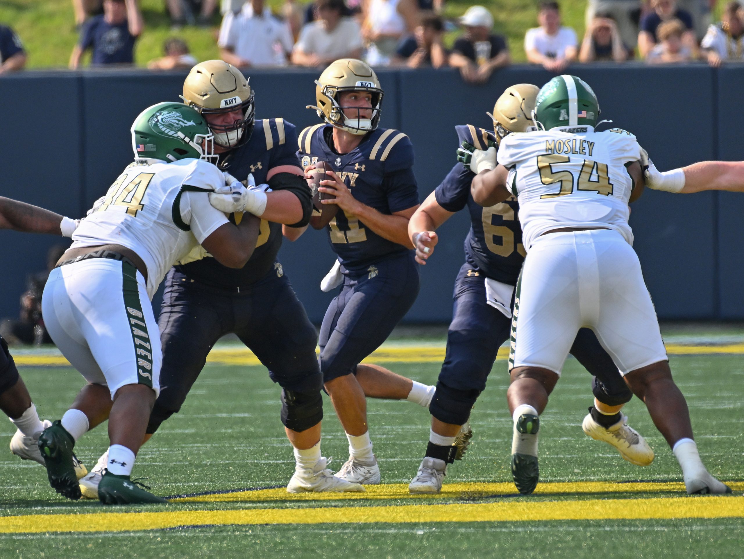 Navy quarterback Blake Horvath looks to throw the ball in...