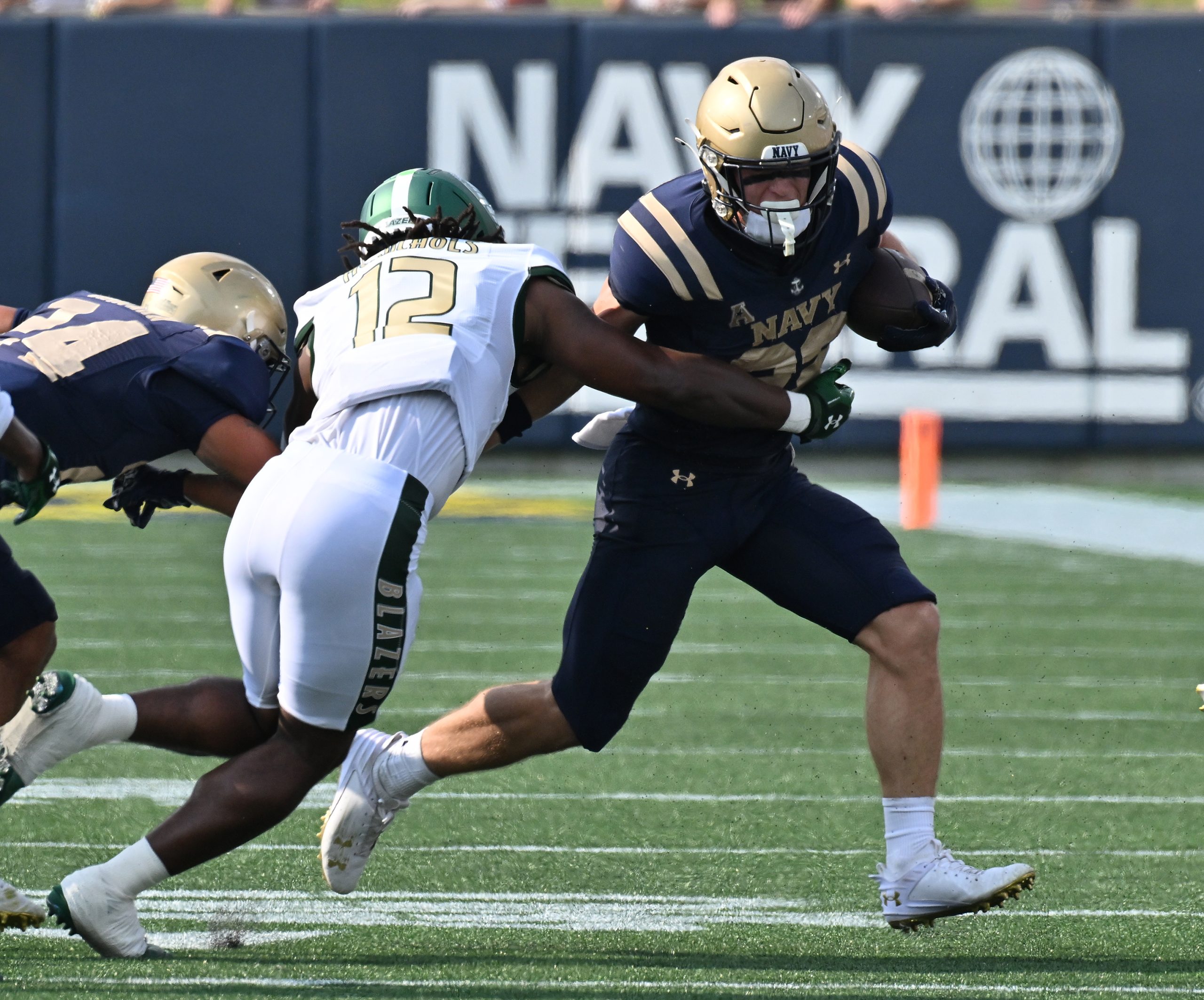 Navy’s Eli Heidenreich runs the ball in the first quarter....
