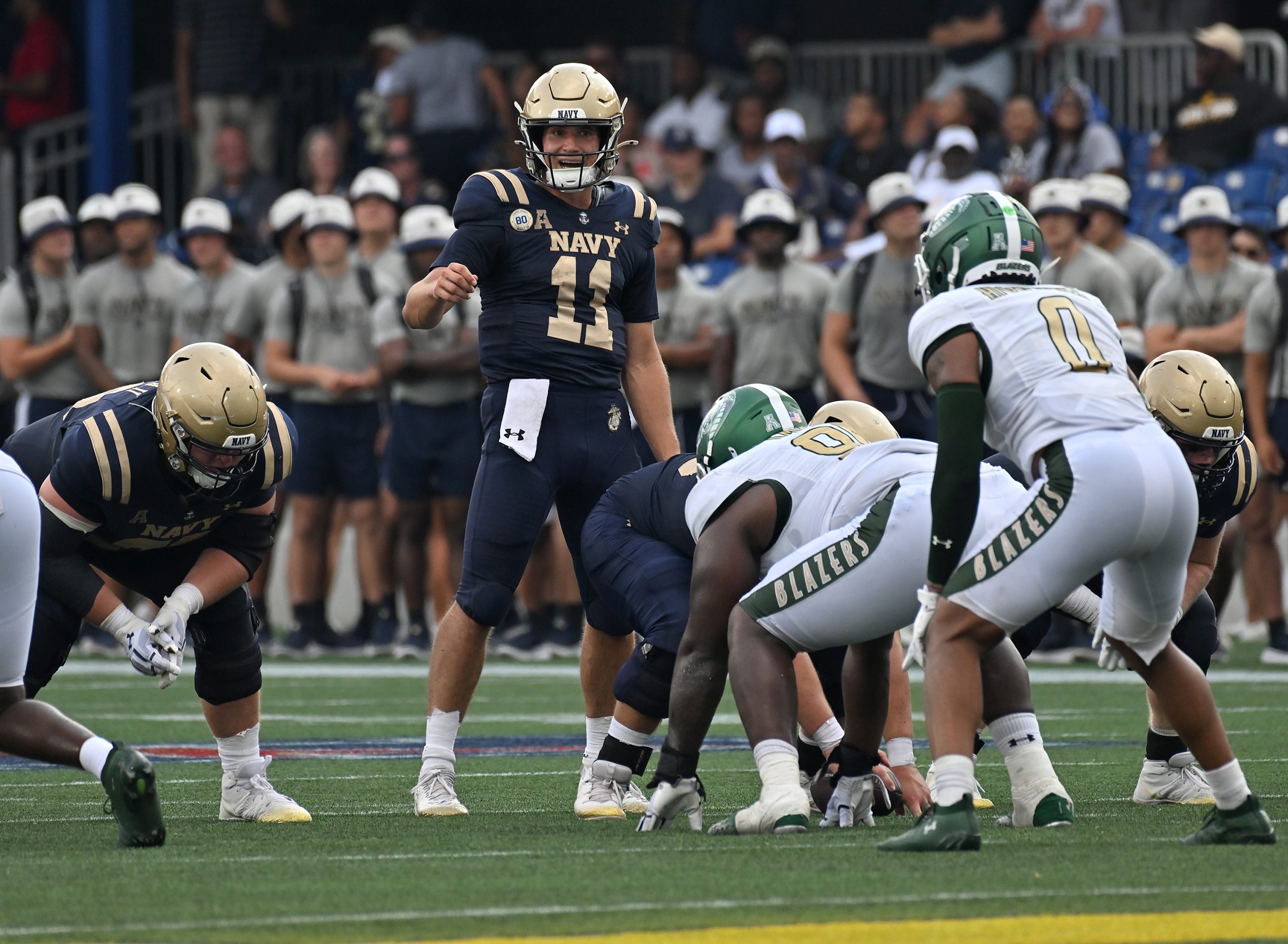 Navy quarterback Blake Horvath surveys the defense before throwing a...