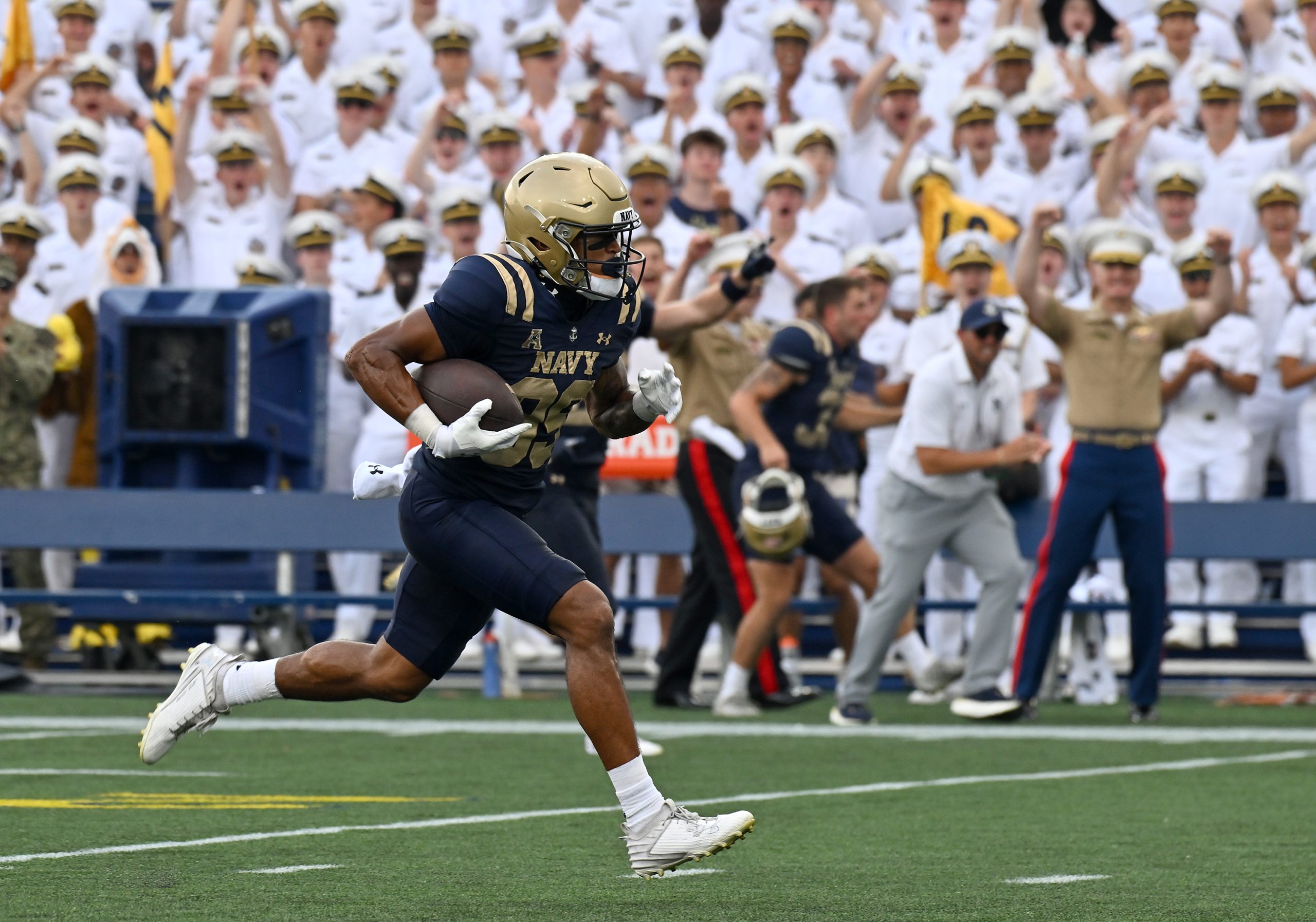 Navy’s Luke Hutchison catches a pass from Blake Horvath and...