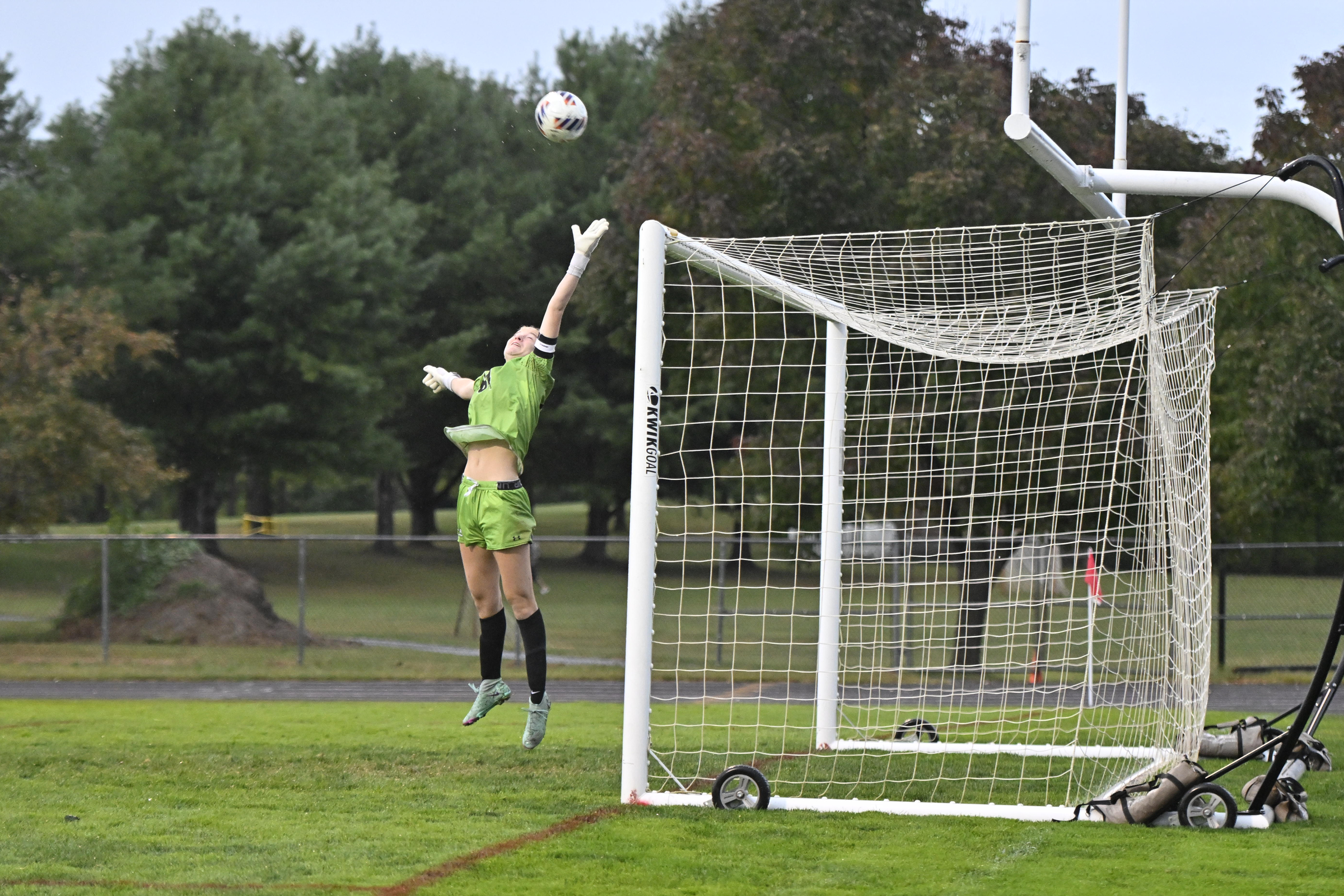 Roland Park's Avery Mason reaches for a ball that just...