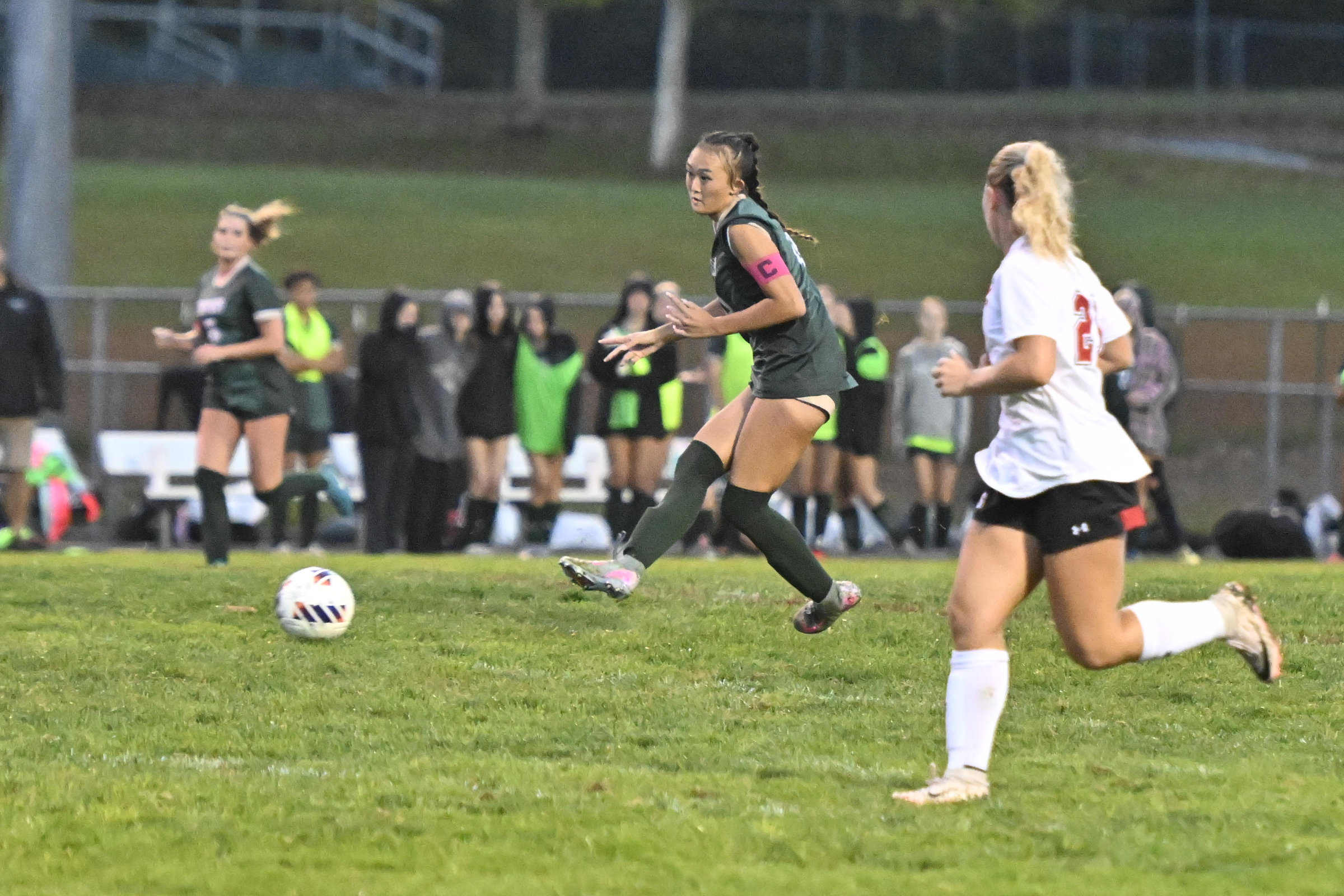 Lenah Ham kicks the ball up field during a soccer...