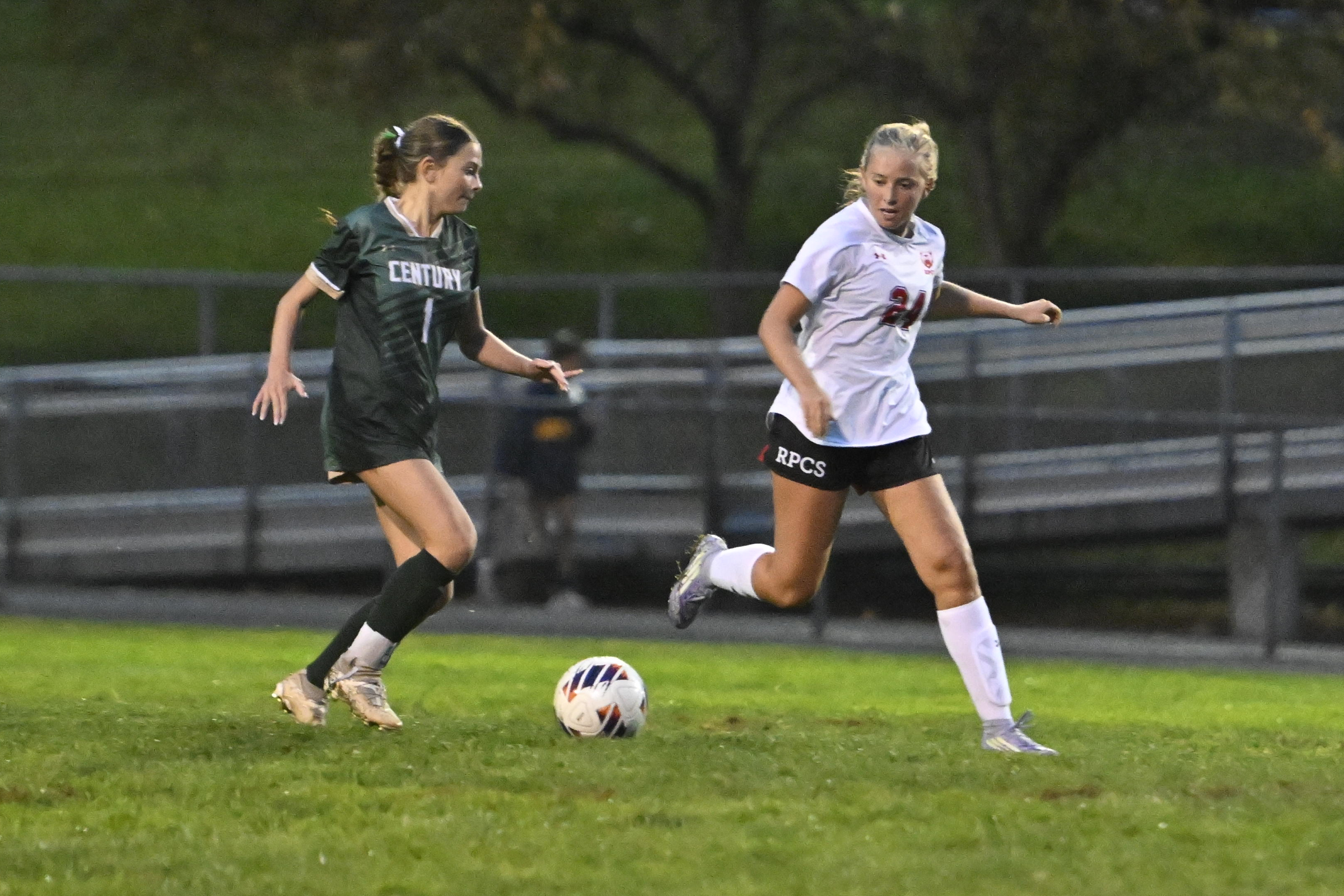 Roland Park's Hadley Root looks to take the ball from...