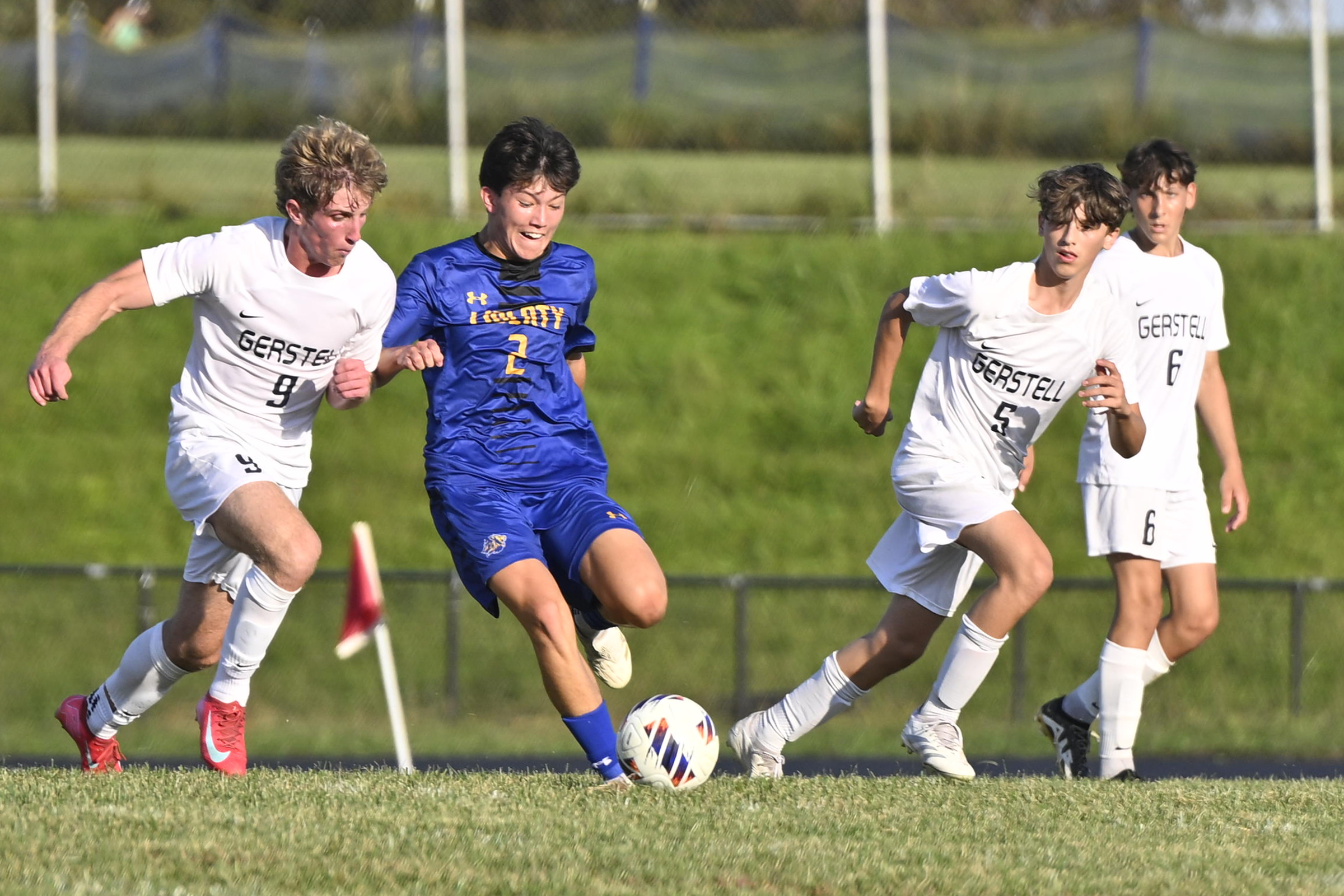 Ryan Clapper works the ball between Gerstell's Darren Fling, left,...