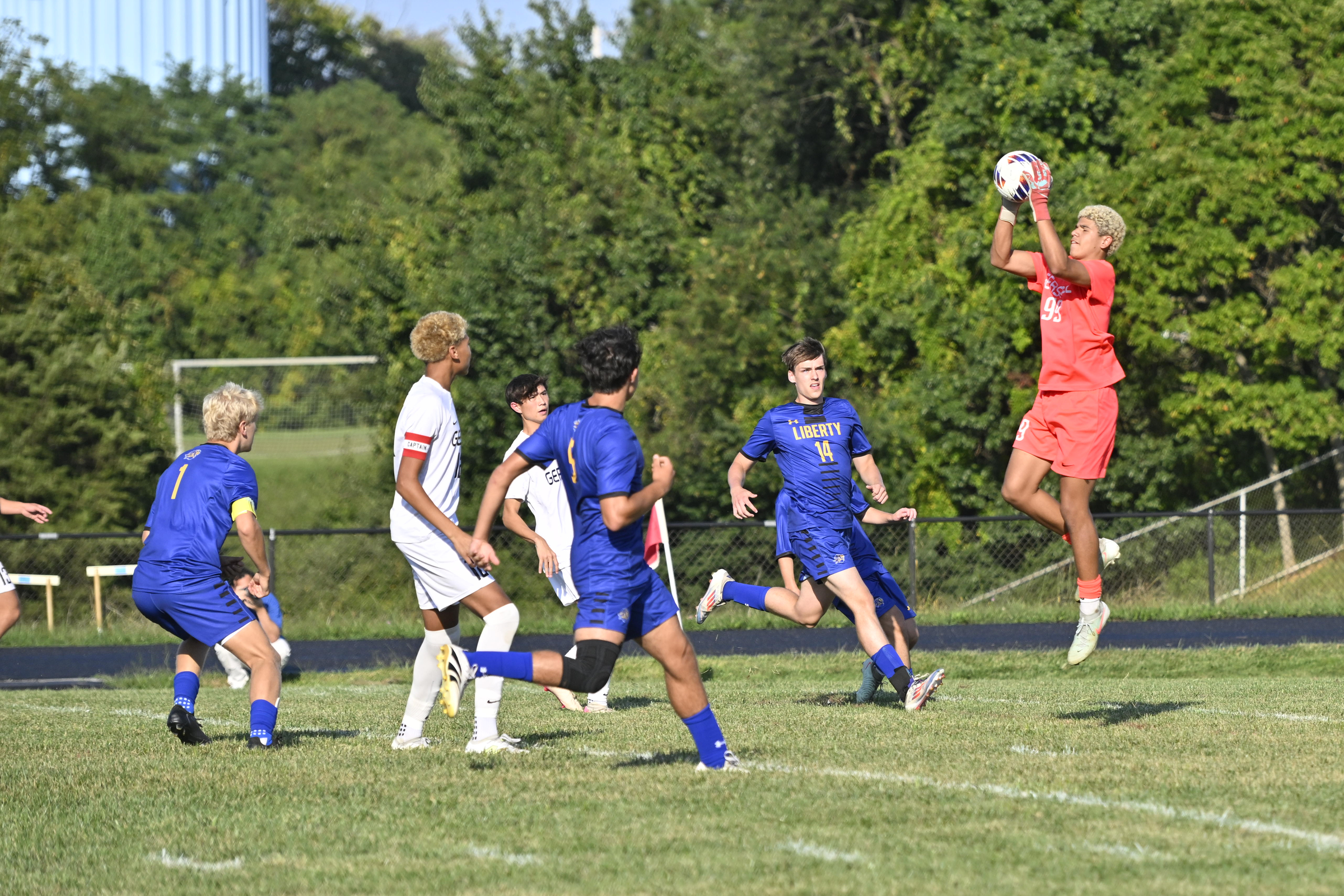 Gerstell goalie Preston Harris leaps high to grab the ball...