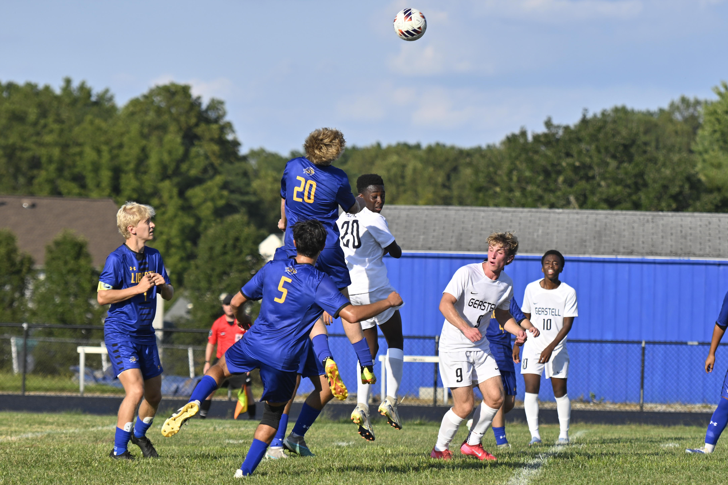 Liberty's Jesse Rowe jumps high to head the ball during...